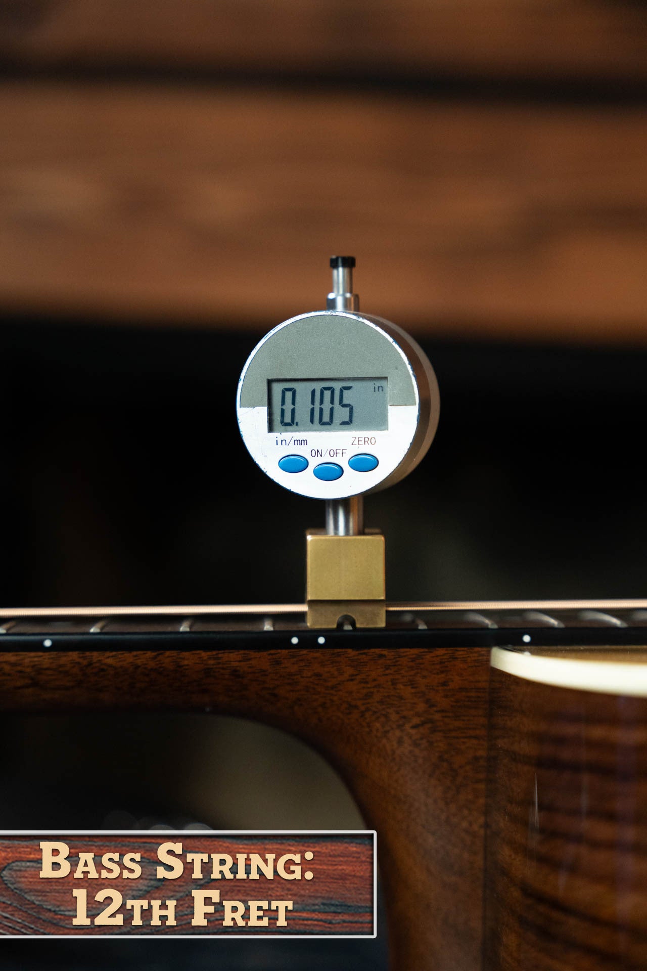 A digital gauge shows the bass string height at the 12th fret of a *New 2025 Model* Martin & Co. D-28 Gloss Spruce/Indian Rosewood Dreadnought (#0650) as 0.105 inches, with a sign noting the Bass String: 12th Fret and Indian Rosewood build.