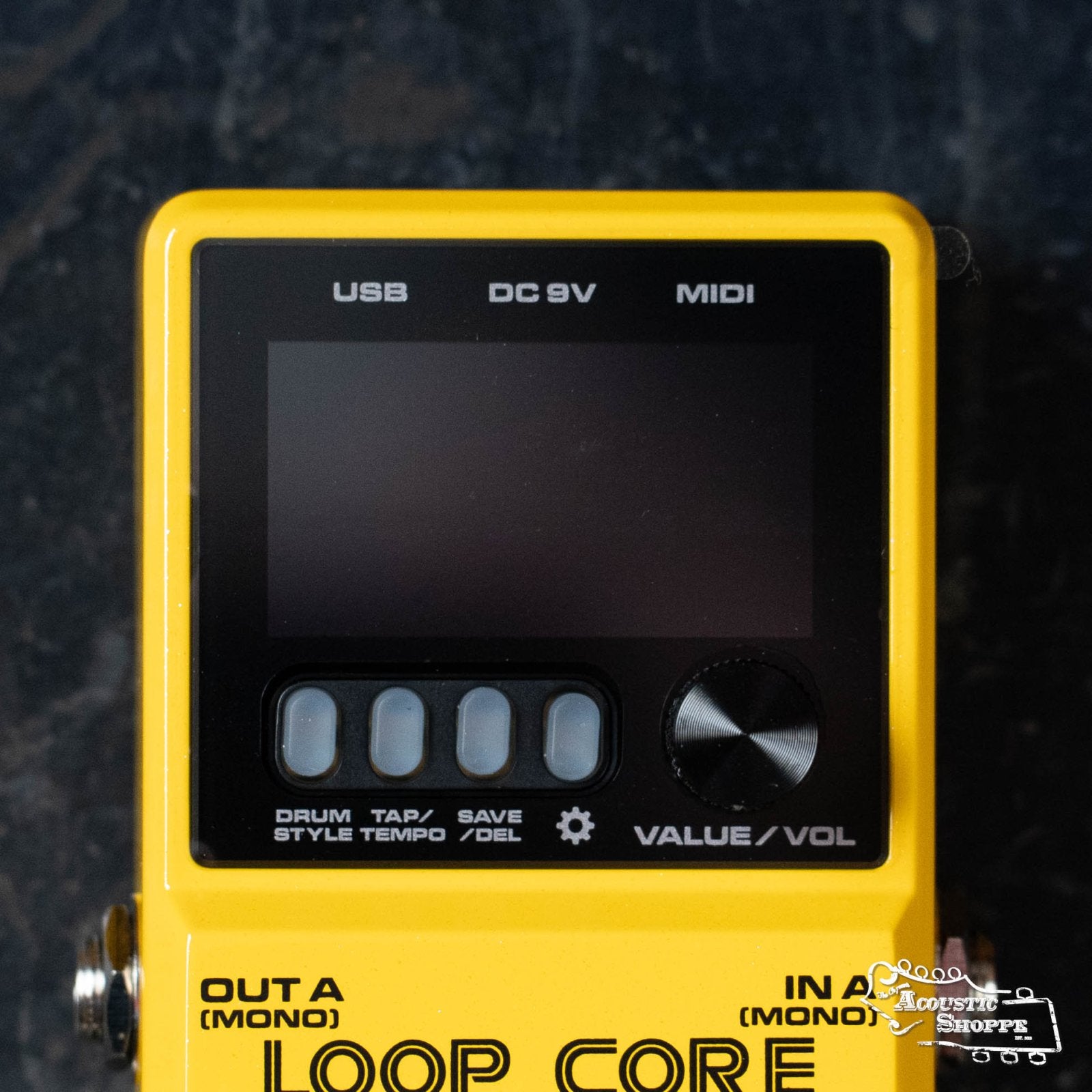 A close-up of the NUX Loop Core Stereo by NUX, a yellow looper pedal featuring a screen, three buttons, a VALUE/VOL knob, and ports labeled USB, DC 9V, and MIDI above the display.