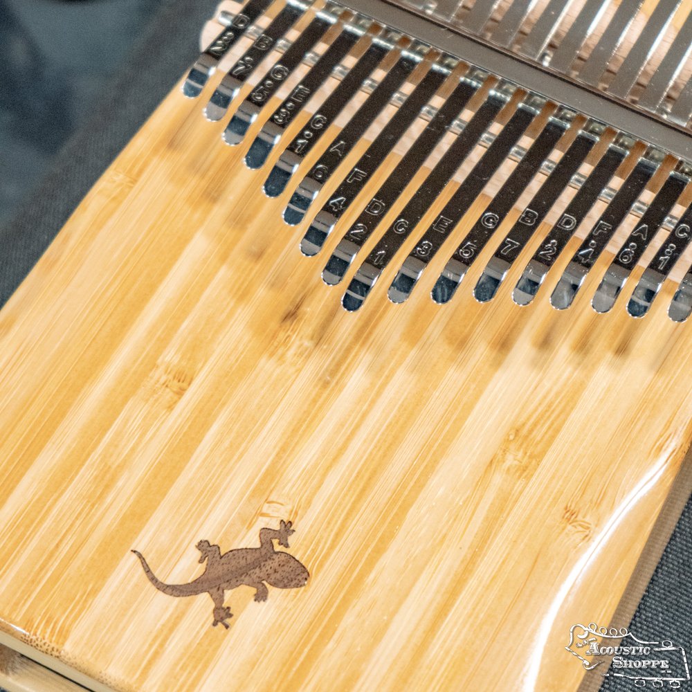 Close-up of the Ortega OKB2 Lizard Series Solid Bamboo Kalimba by Ortega, featuring 17 labeled keys in C major and an engraved lizard design on its bamboo body.