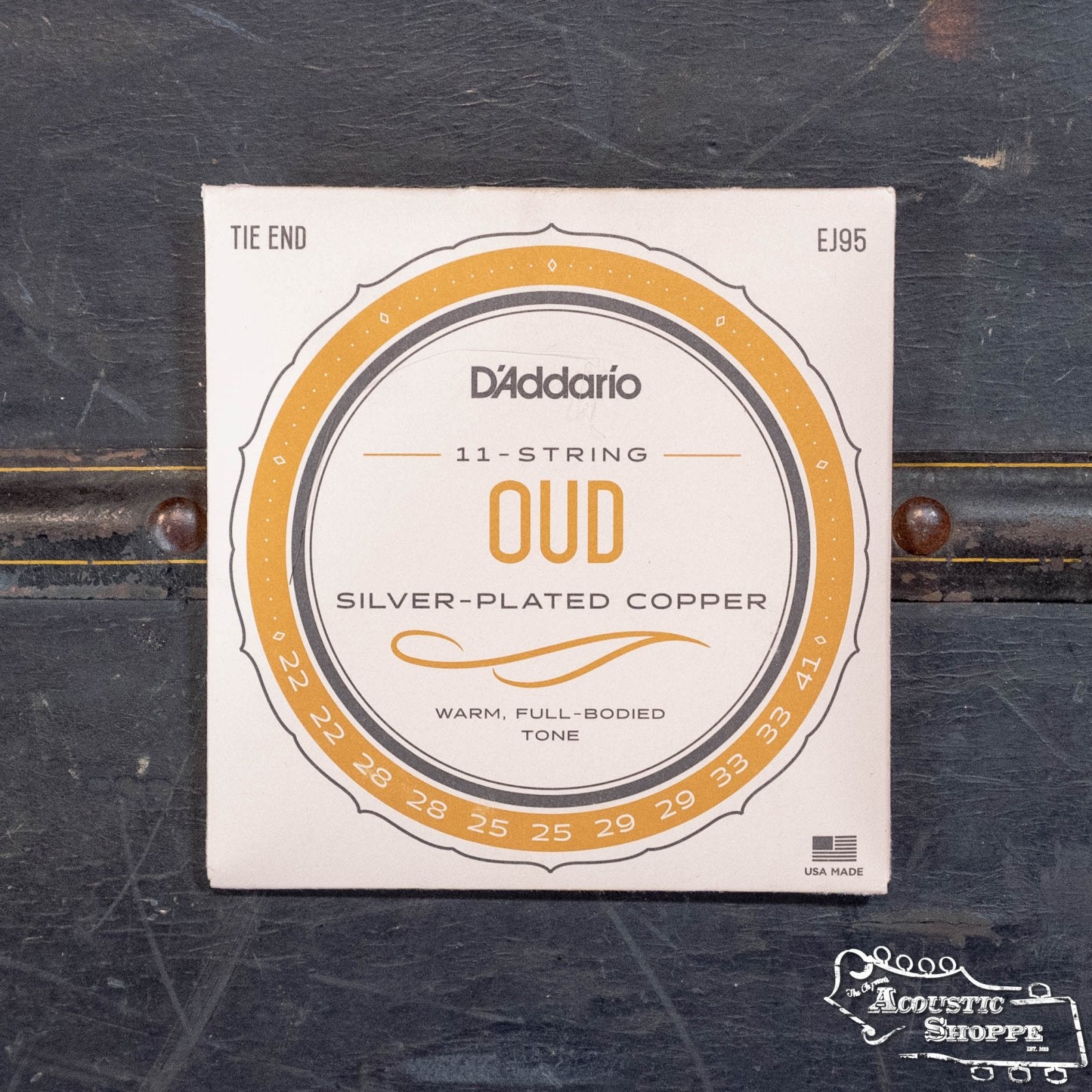 A pack of DAddario Oud Strings EJ95 Silver on Nylon (gauges 22–41) delivers a warm, full-bodied tone for acoustic instruments and is shown on a dark textured surface.