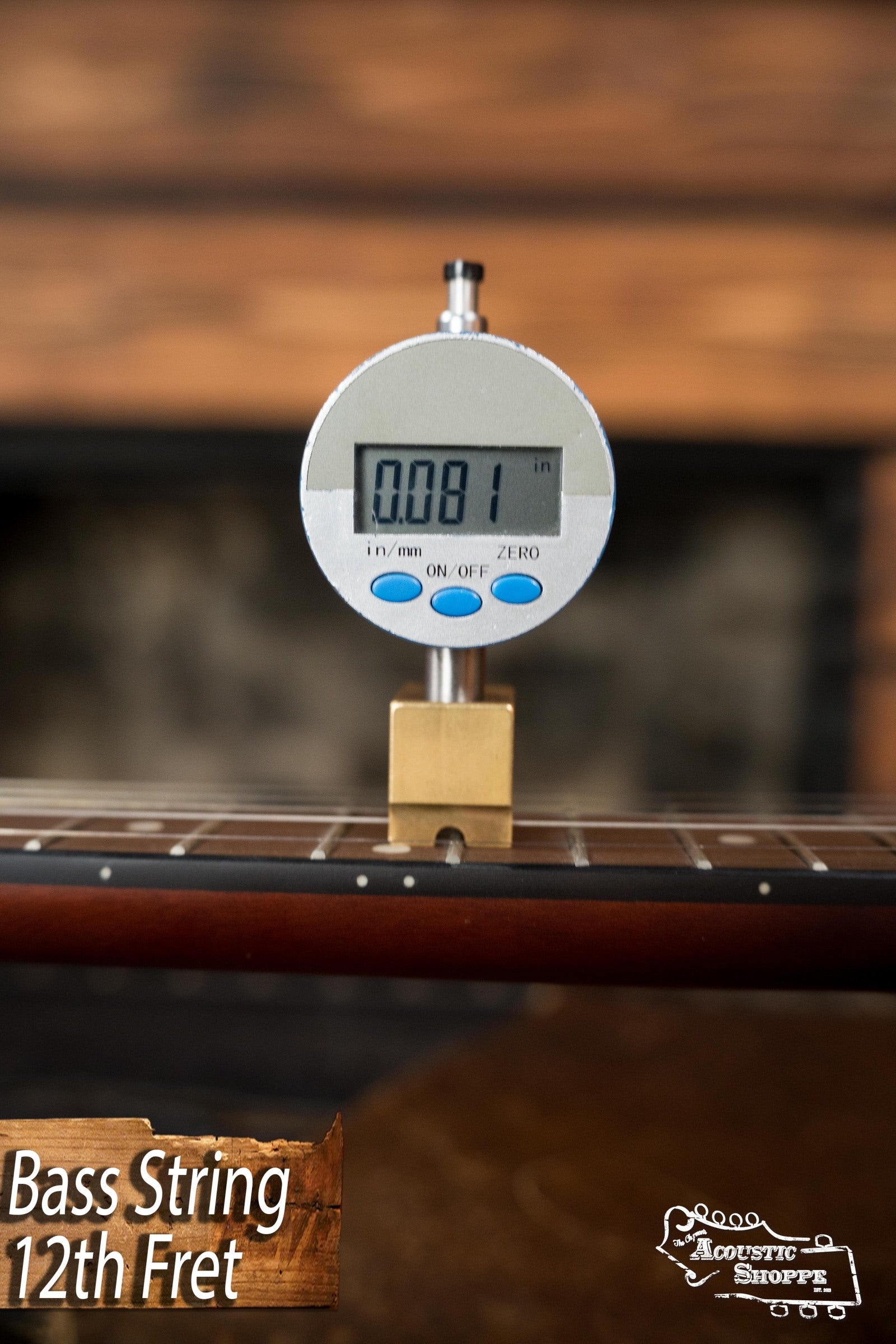 A digital gauge measures bass string height at the 12th fret of a Recording King RKH-05 Dirty 30s Resonator Banjo #2563, showing 0.081 inches. Bass String 12th Fret and “Acoustic Shoppe” appear at the bottom of the image.