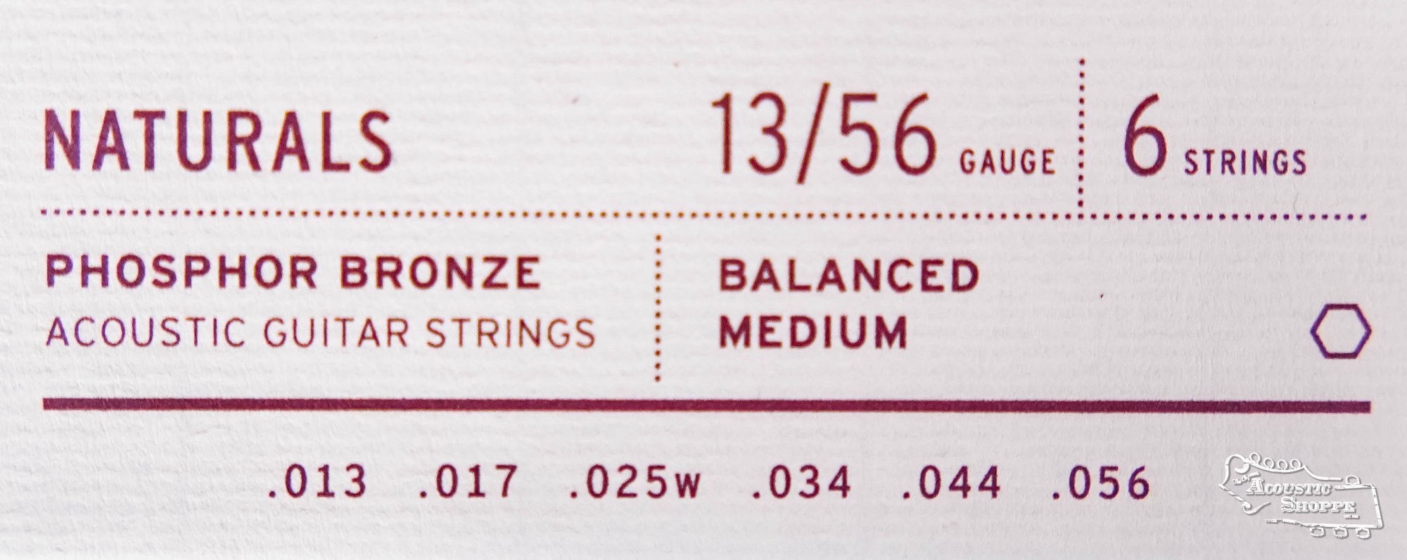 Close-up of Stringjoy Naturals Medium Gauge (13-56) Phosphor Bronze Acoustic Guitar Strings packaging, showing 6 strings: .013, .017, .025w, .034, .044, .056—balanced for acoustic guitars by Stringjoy.