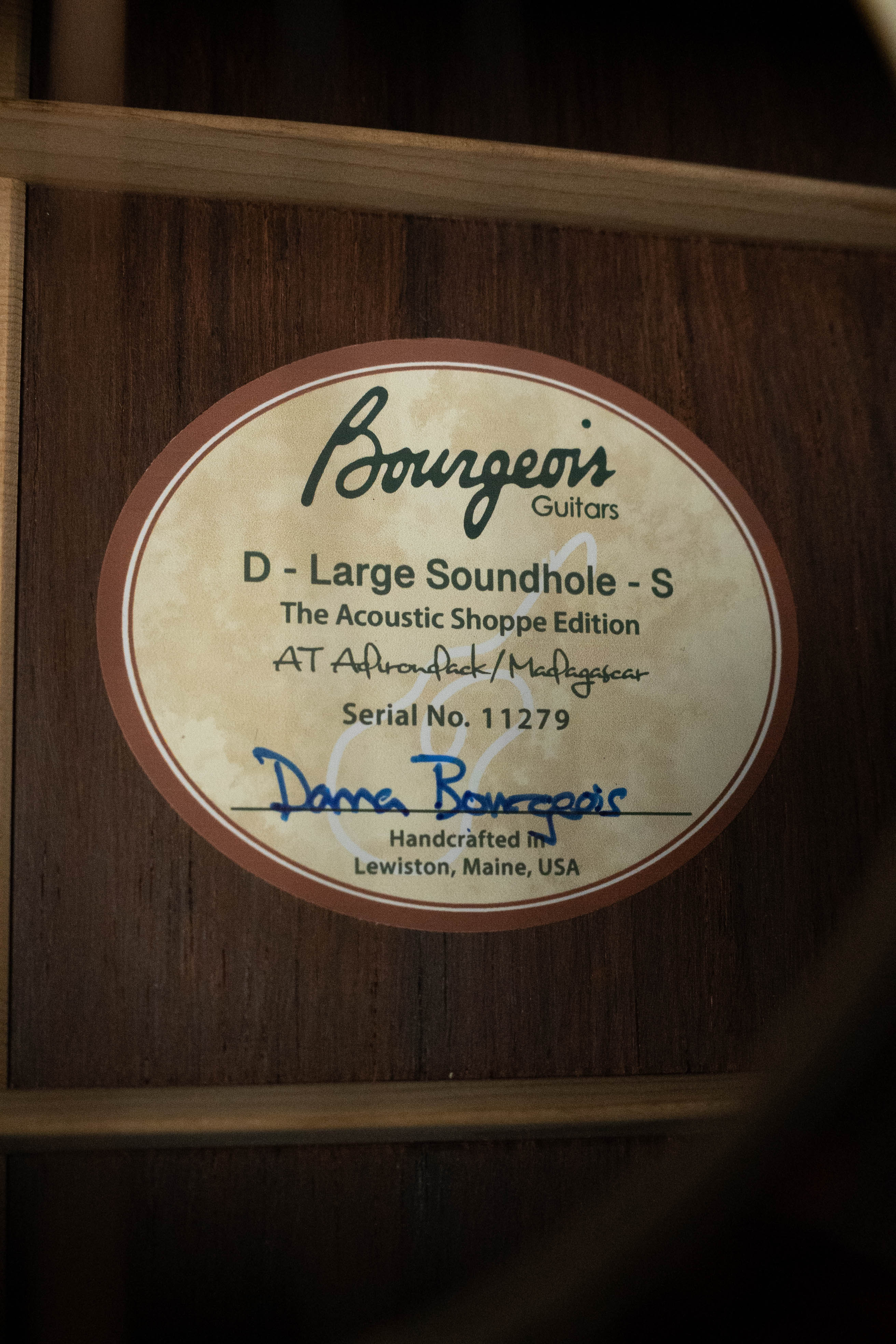 A close-up of a Bourgeois label inside the soundhole reads: Bourgeois, Professional Series Satin Dreadnought Guitar, TAS LSH – Pre-Order 25% Deposit ONLY. Handcrafted in Lewiston, Maine, USA.