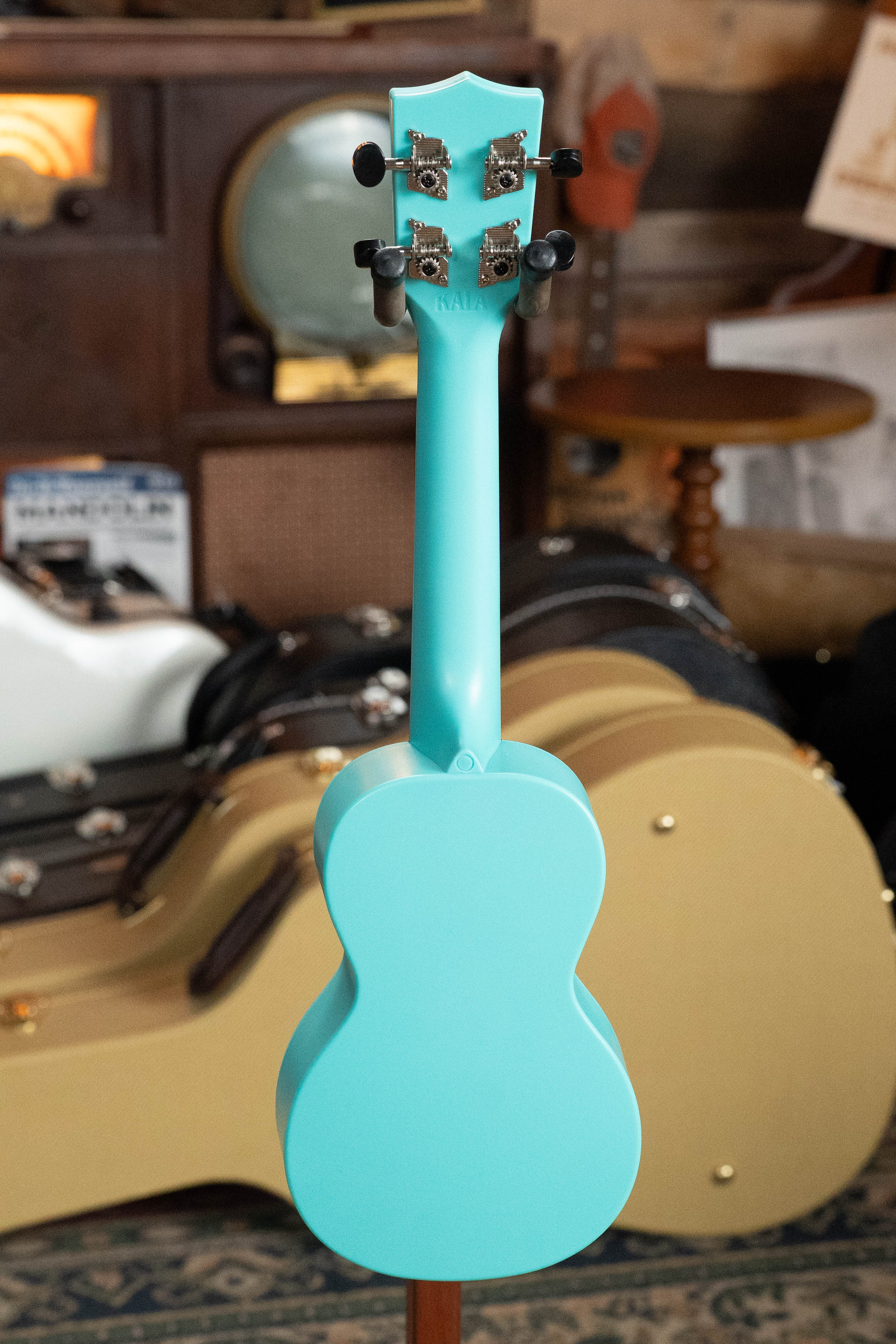 Aqua mist glow-in-the-dark soprano ukulele with smooth finish and black tuning pegs, displayed from the back. - The Waterman Aqua Mist Glow-In-The-Dark Soprano Recycled Ukulele - Kala Brand - Default Title