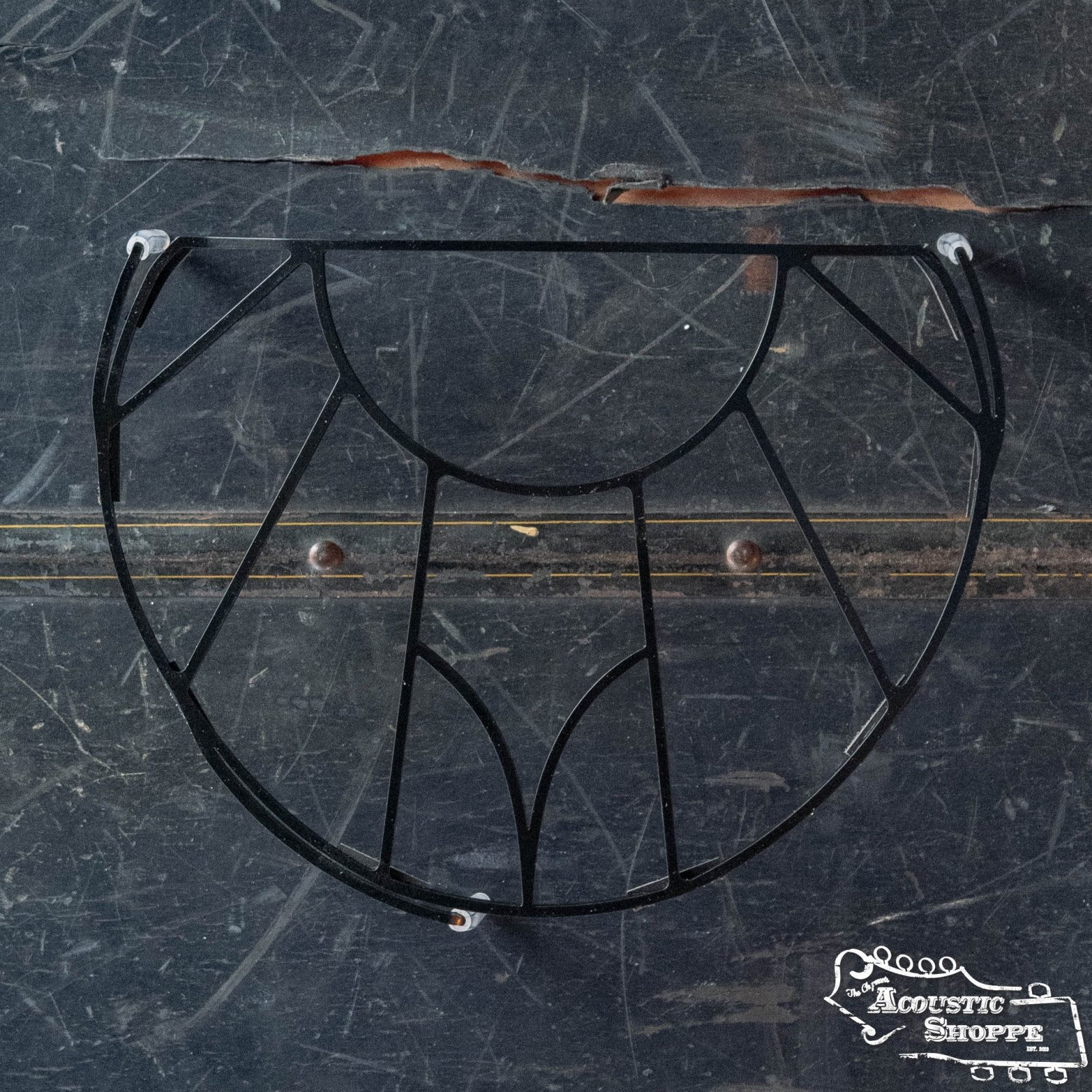 A Tone-Gard Mandolin - Vintage by Tone-Gard, featuring an intricate black metal design, rests on a scratched dark surface. The Acoustic Shoppe logo appears in the corner, highlighting this unique instrument back protector.