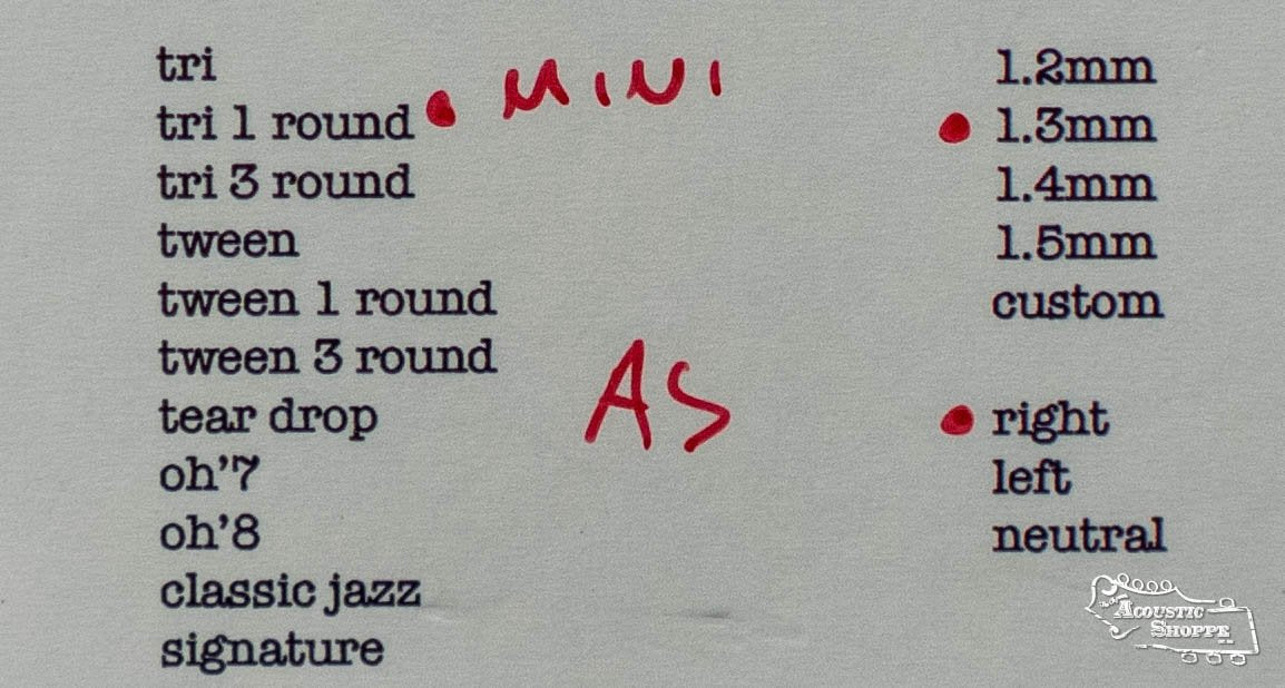 A list of ToneSlabs pick shapes and sizes, including the TAS Custom Mini Tri 1Round Guitar Pick - 1.3mm (Exclusive Color), with black text, handwritten red notes reading MINI and AS, some red dots, and The Acoustic Shoppe logo in the bottom right.