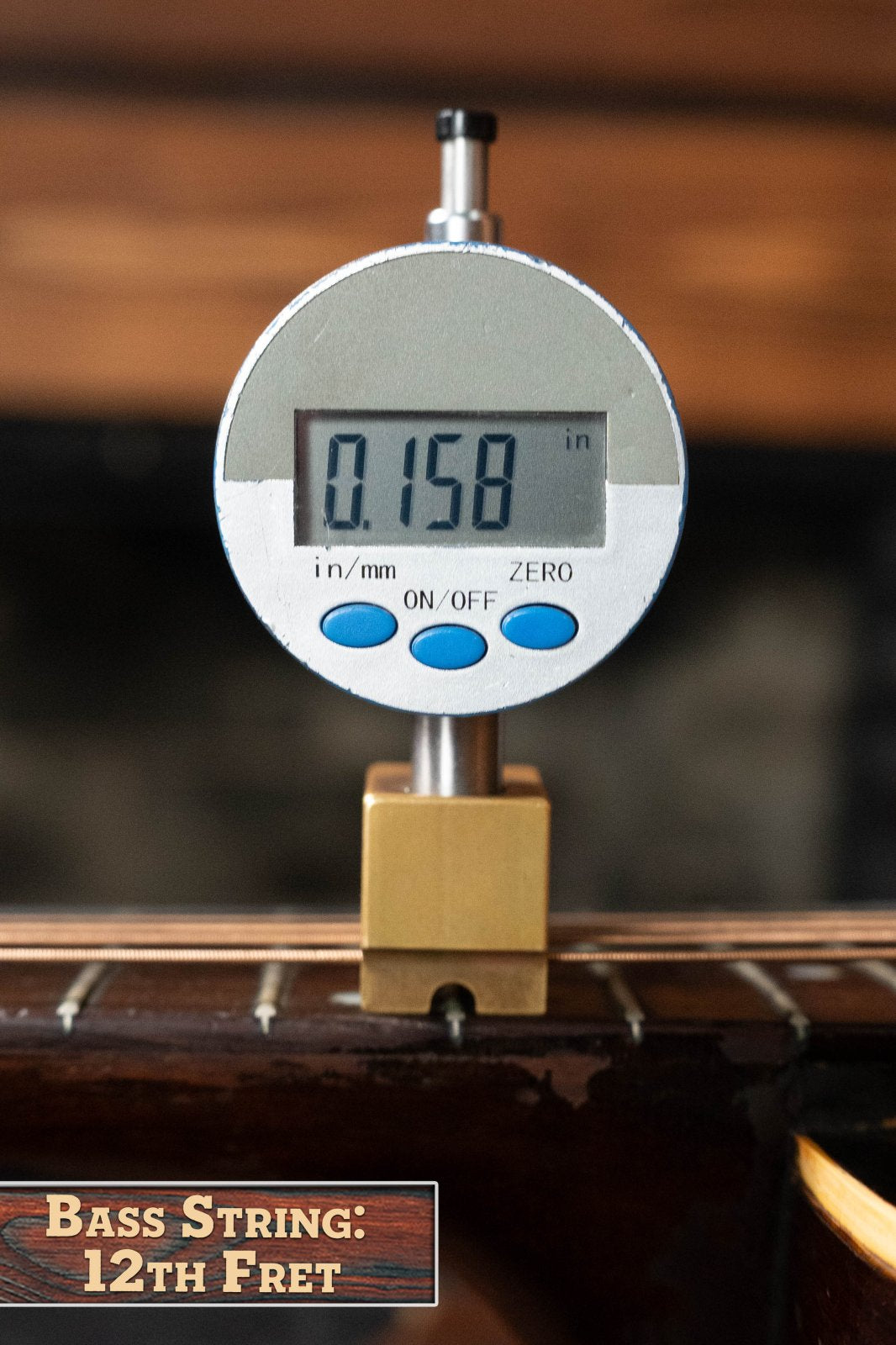 A digital gauge reads 0.158 inches, measuring the bass string height above the 12th fret on a (Used) 1933 Gibson LOO Adirondack/Mahogany OO Tobacco Sunburst Acoustic Guitar #550 by Gibson. A label below says Bass String: 12th Fret.