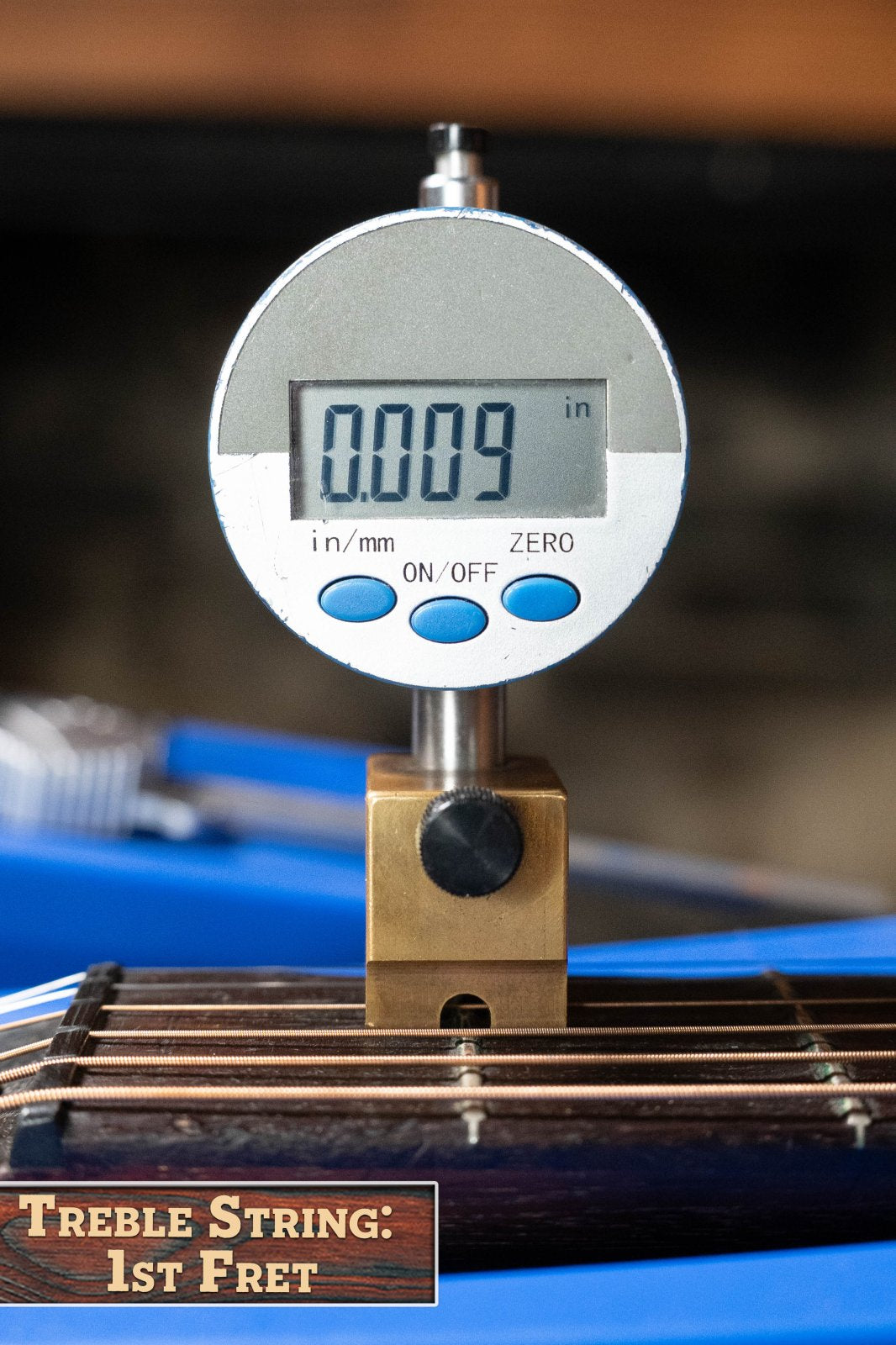 A digital gauge reads 0.009 inches for the treble string height at the 1st fret on a (Used) 1933 Gibson LOO Adirondack/Mahogany OO Tobacco Sunburst Acoustic Guitar #550 by Gibson. A label below states: Treble String: 1st Fret.