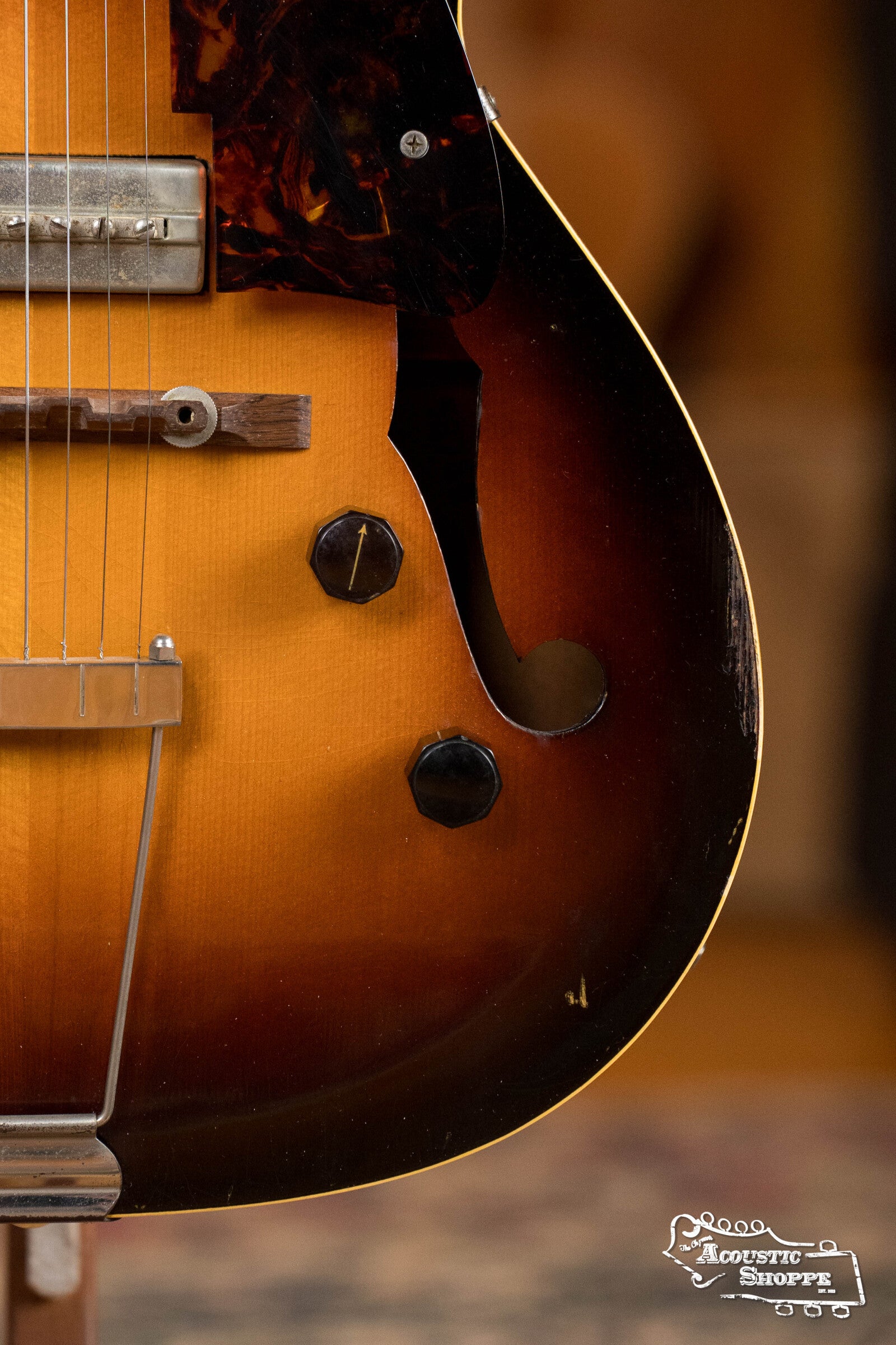 Close-up of a (Used) 1942 Gibson ES-125 hollow-body electric guitar by Gibson, featuring an f-hole, P-90 pickup, control knobs, pickguard, and bridge. Acoustic Shoppe logo is visible in the bottom right corner.