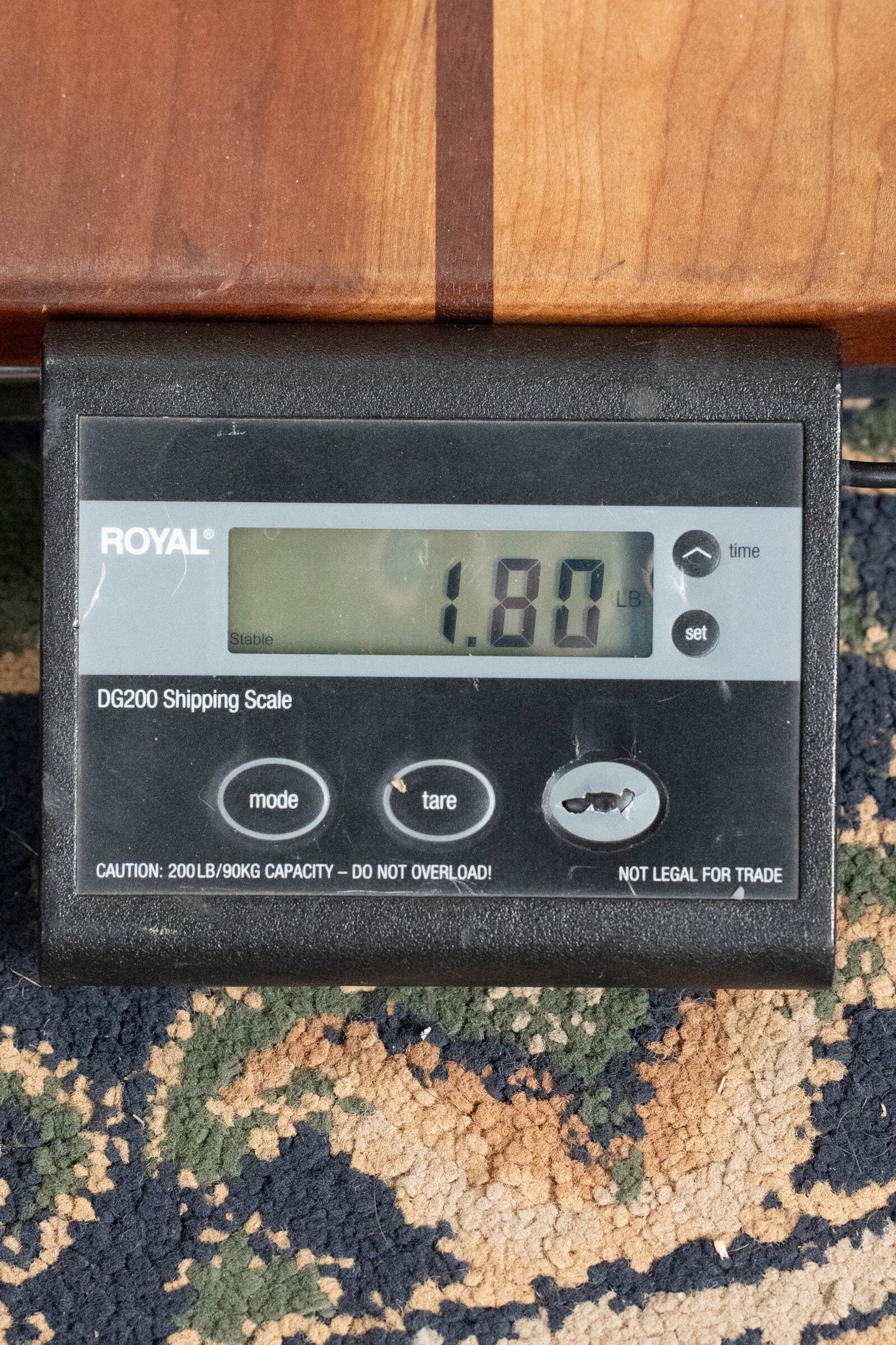A digital scale shows 1.80 lbs for a (Used) 2003 Gibson Mastermodel A9 Spruce/Maple Mandolin #7040 by Gibson, displayed on carpet beneath the mandolin—ideal for bluegrass players seeking quality tone.