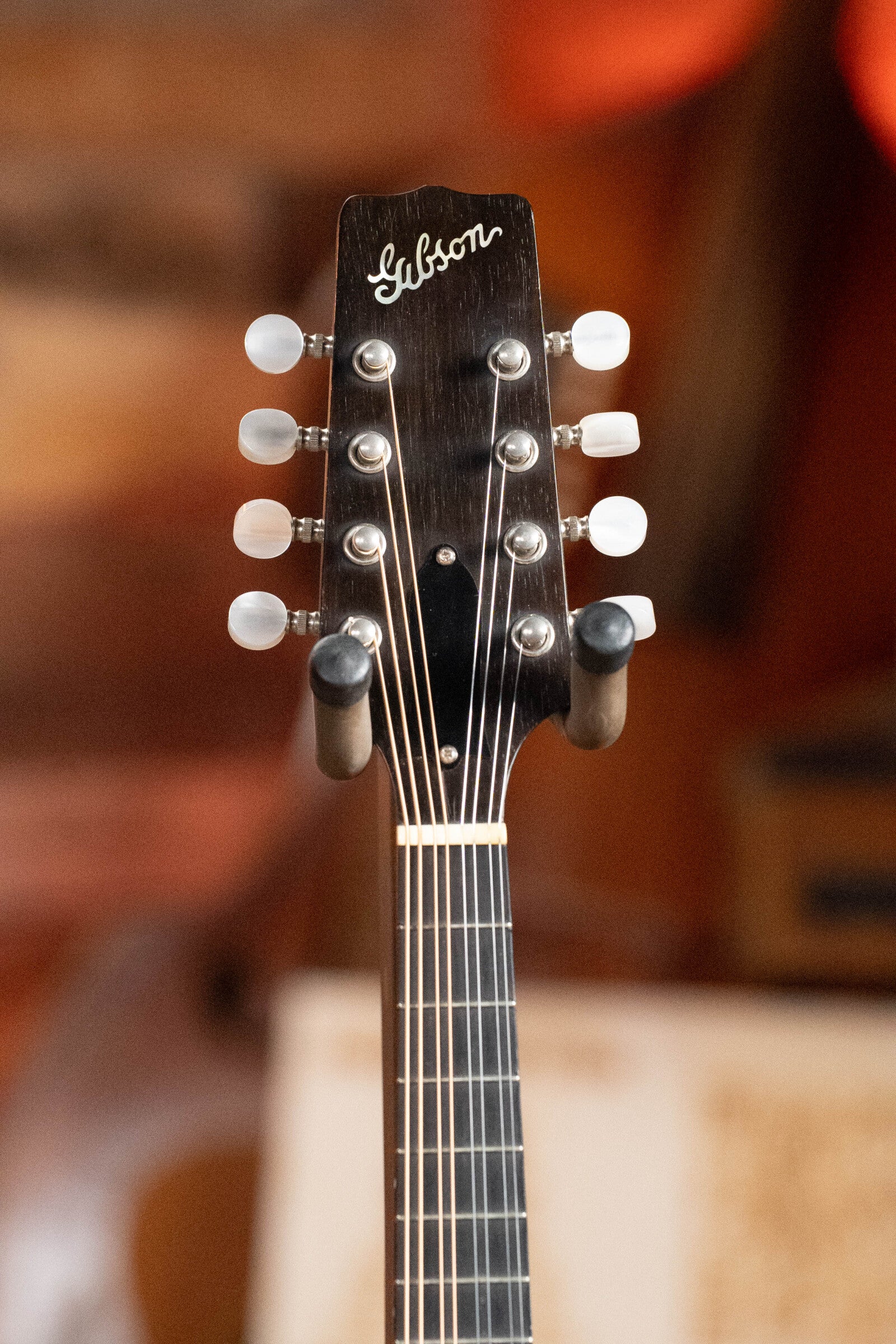 Close-up of the headstock on a (Used) 2003 Gibson Mastermodel A9 Spruce/Maple Mandolin #7040, featuring tuning pegs and the iconic Gibson logo—ideal for bluegrass fans and collectors.