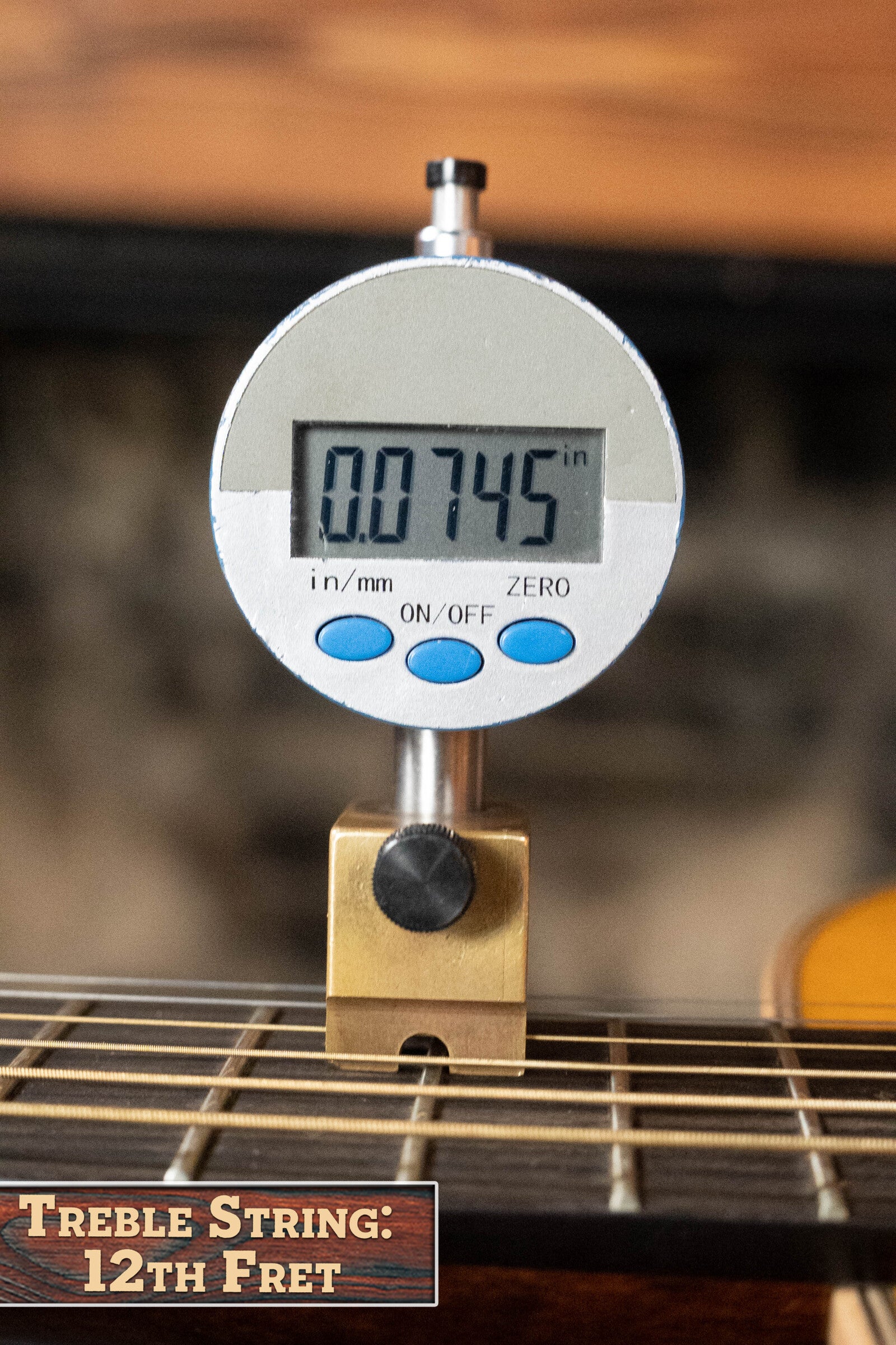 A digital gauge shows a string height of 0.0745 inches at the 12th fret of a (Used) 2022 Martin Brook Ligertwood 000-28 Spruce/Rosewood OOO Acoustic Guitar by Martin & Co., labeled “Treble String: 12th Fret” on this vintage tone acoustic guitar.