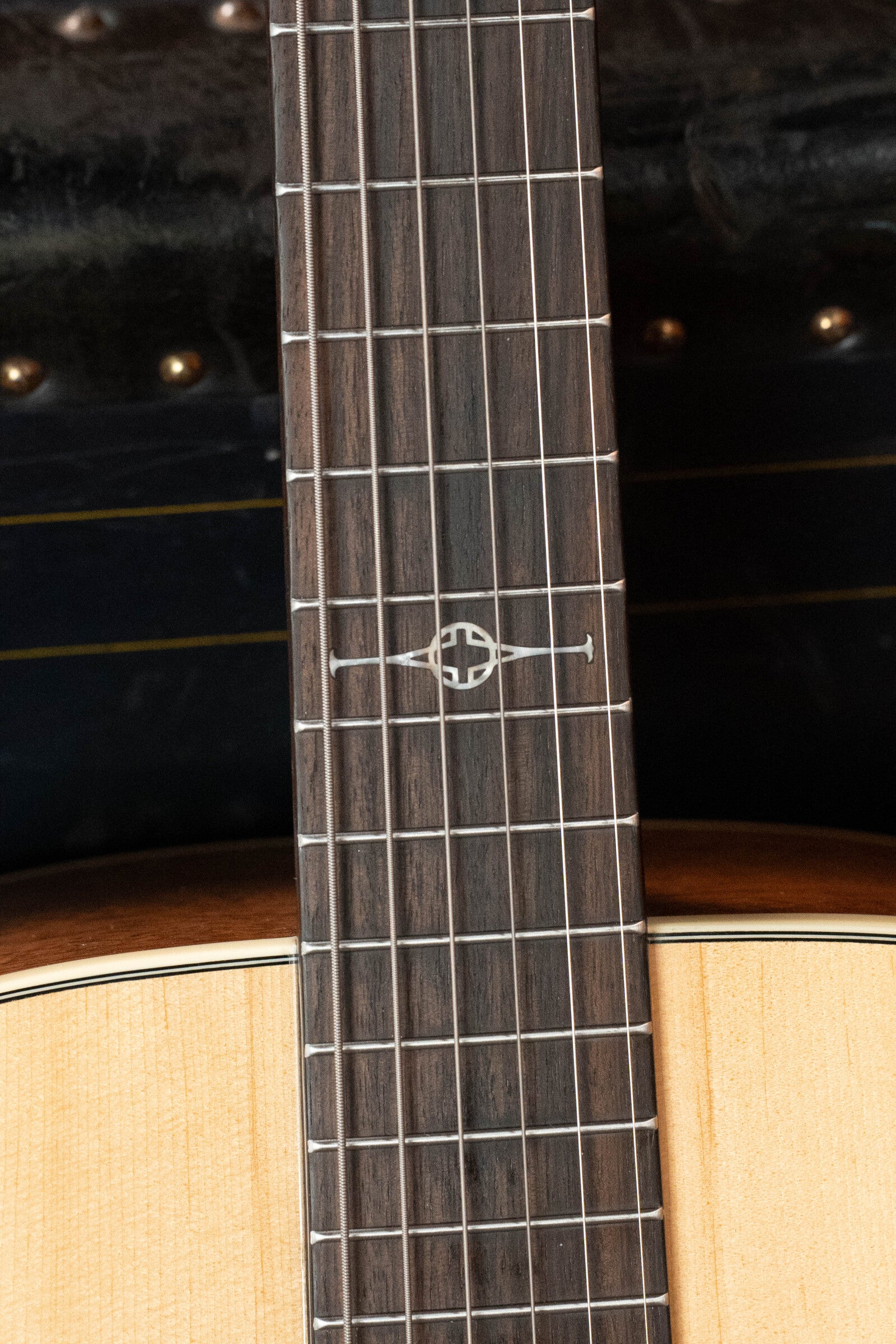 Close-up of the Alvarez (Used) 2024 AD60 Sitka/Mahogany Dreadnought Acoustic Guitar #0300 fretboard, highlighting its unique 12th-fret inlay, wooden body, and metallic frets.
