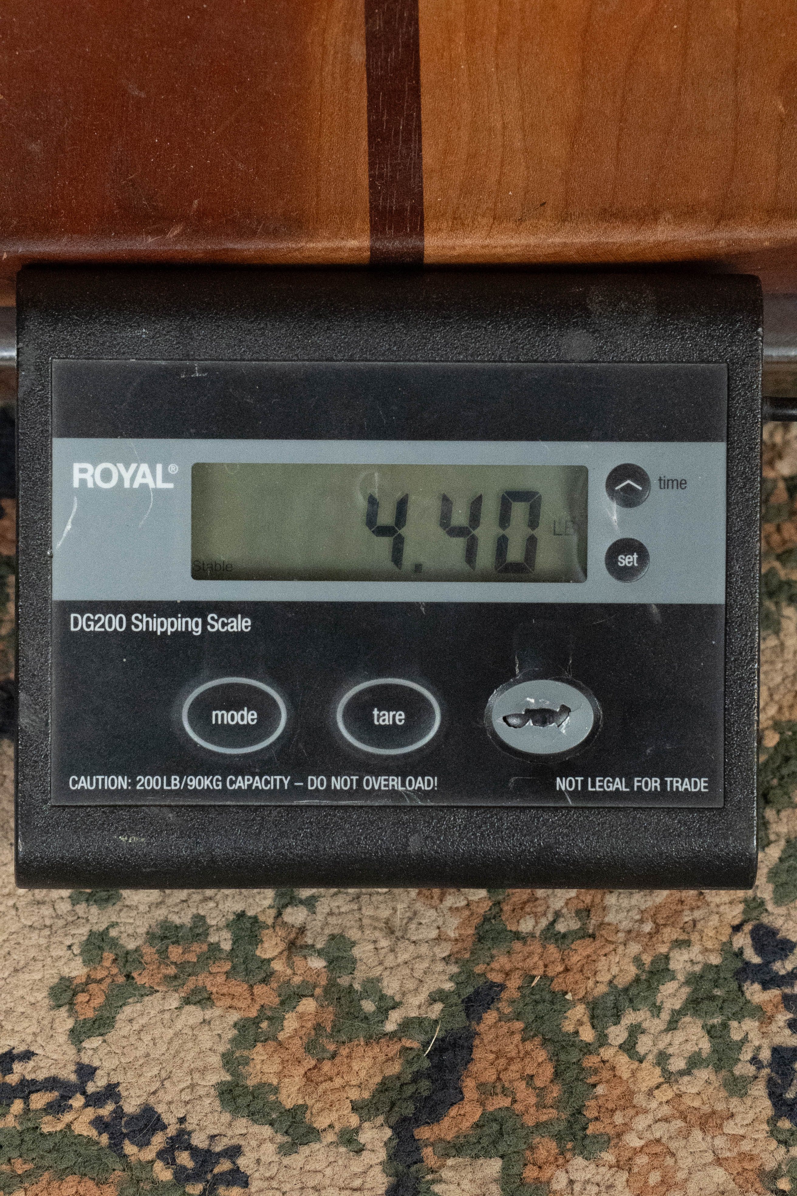 A ROYAL DG200 shipping scale on a patterned carpet shows 4.40 lbs—ideal for weighing the (Used) 2025 Eastman L-OOSS-LTD-KOA Limited Edition Luthier Series All Koa Acoustic Guitar #9075 by Eastman Guitars.