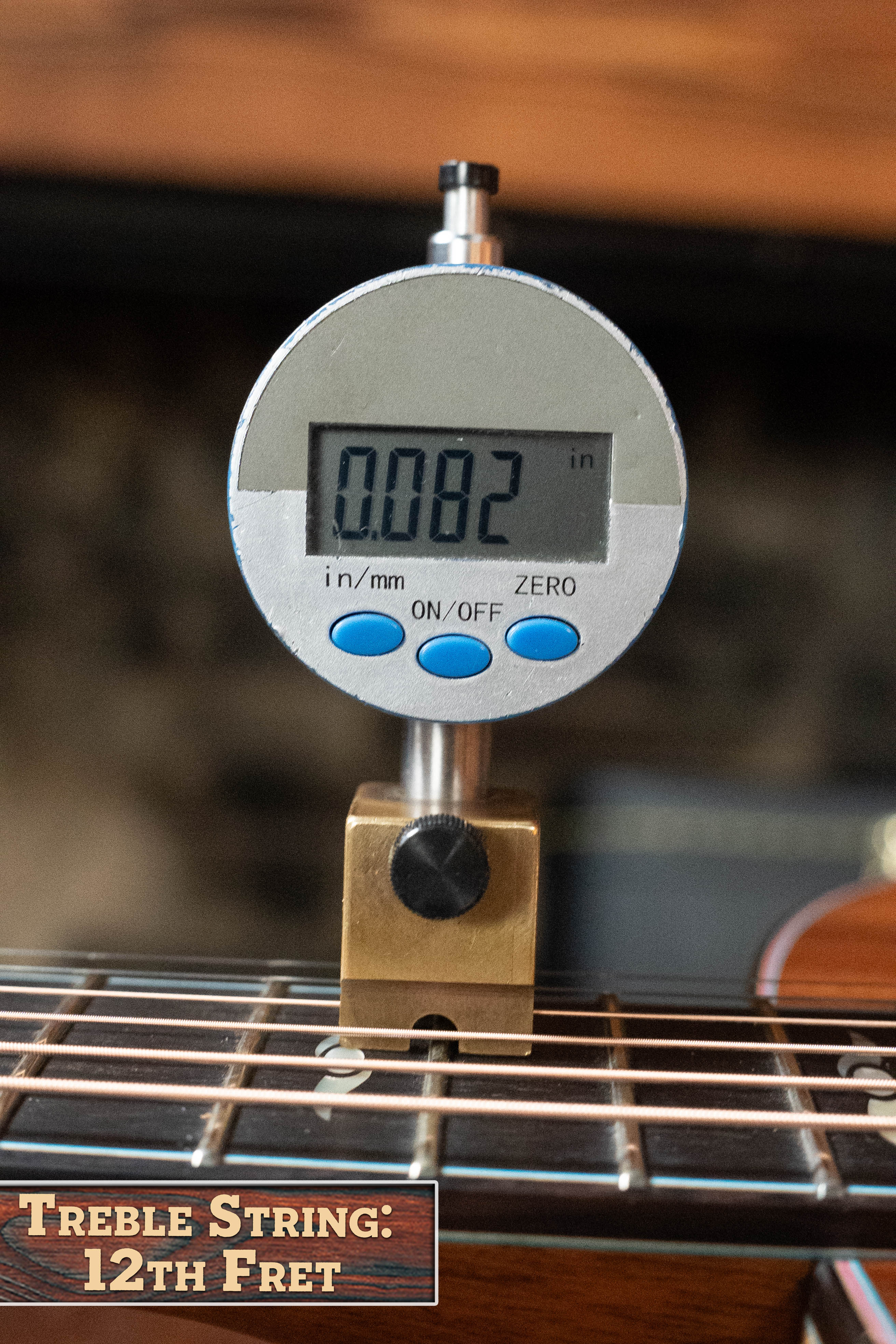 A digital gauge shows a 12th fret string height of 0.082" on an Eastman Guitars (Used) 2025 L-OOSS-LTD-KOA Limited Edition All Koa Acoustic Guitar #9075, highlighted by the “Treble String: 12th Fret” text in the image.