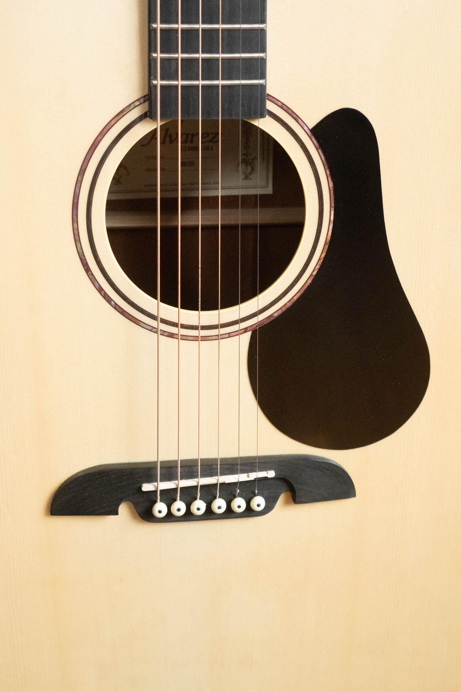 Close-up of the Alvarez (Used) 2025 RD-26 Spruce/Mahogany Dreadnought Acoustic Guitar #0161, showcasing the sound hole, pickguard, bridge, and strings on its light wood finish—a great student-friendly choice.
