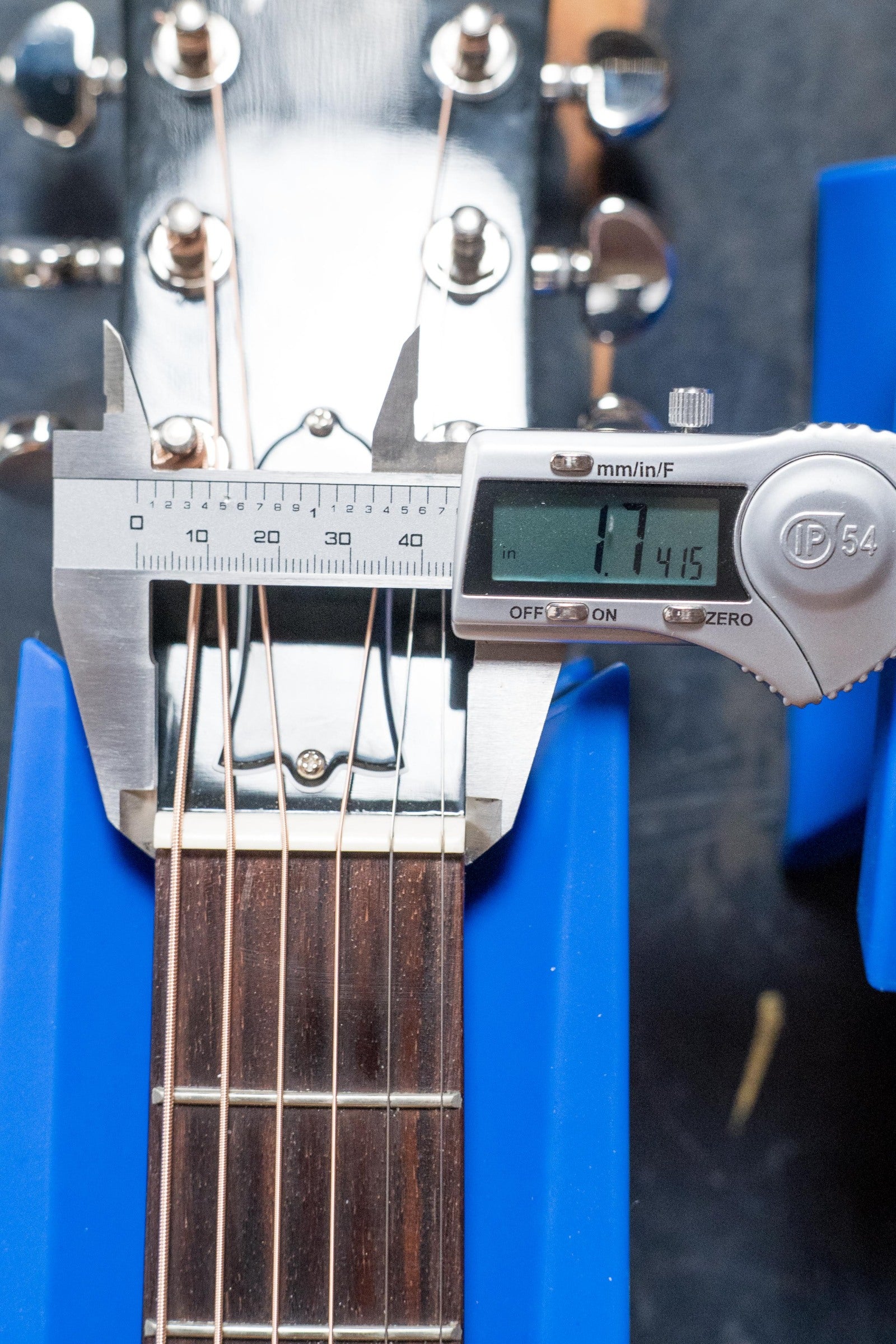 A digital caliper shows a 1.415-inch nut width on the Gibson J45 Standard Sitka/Mahogany Round Shoulder Vintage Sunburst Dreadnought Guitar w/K&K Pickup (#4111), resting in a blue support.