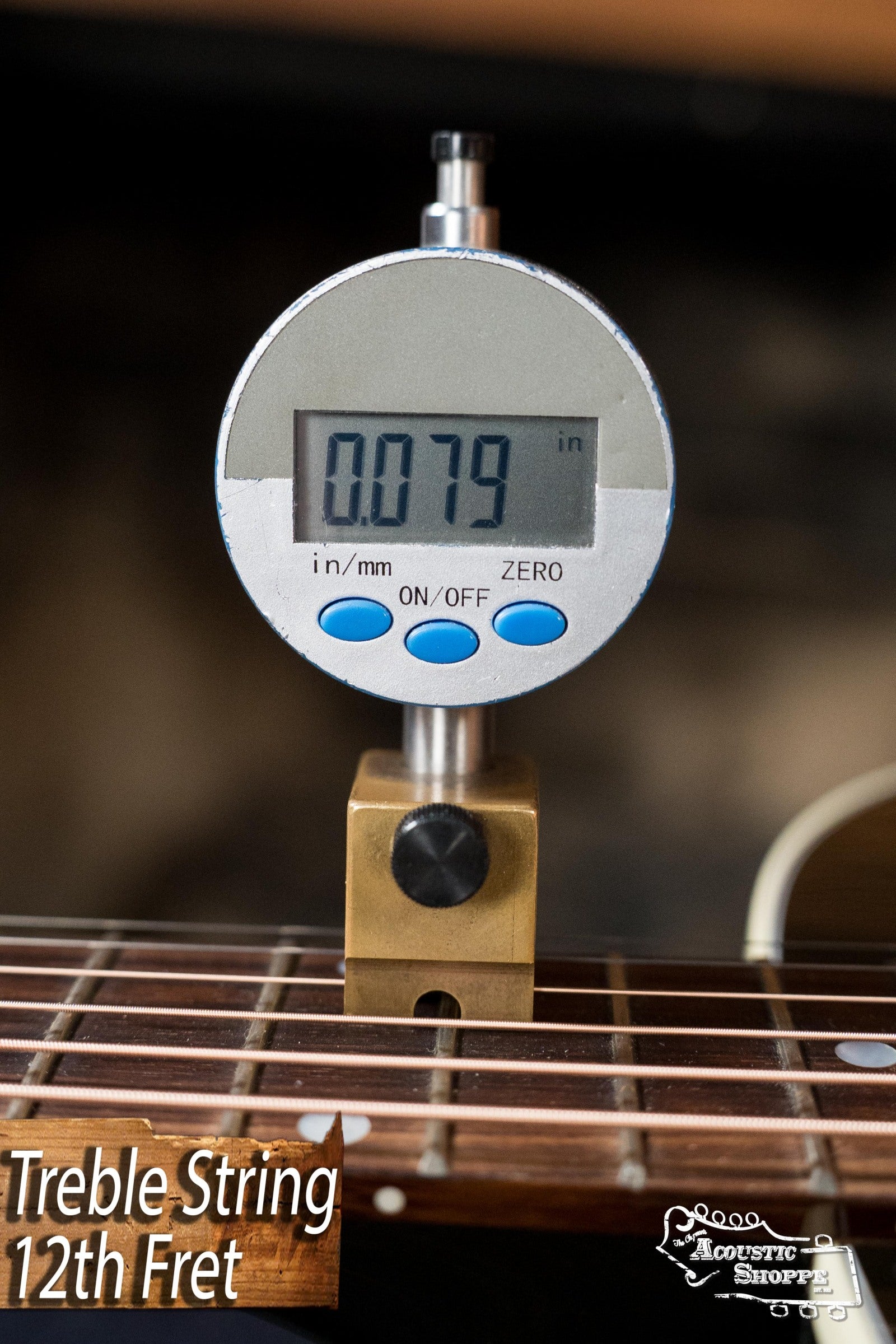 A digital gauge reads 0.079 inches at the 12th fret treble string of a used Gibson J45 Standard Sitka/Mahogany Dreadnought Guitar (#4111). Image text: “Treble String 12th Fret” with Acoustic Shoppe logo at bottom right.