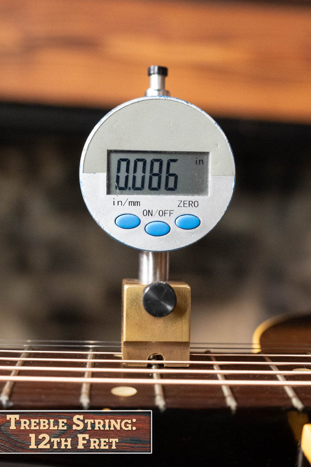 A digital gauge measures the treble string height at the 12th fret of a (Used) 1958 Gibson LG-1 Spruce/Mahogany Acoustic Guitar #2758, showing 0.086 inches. Brand: Gibson.