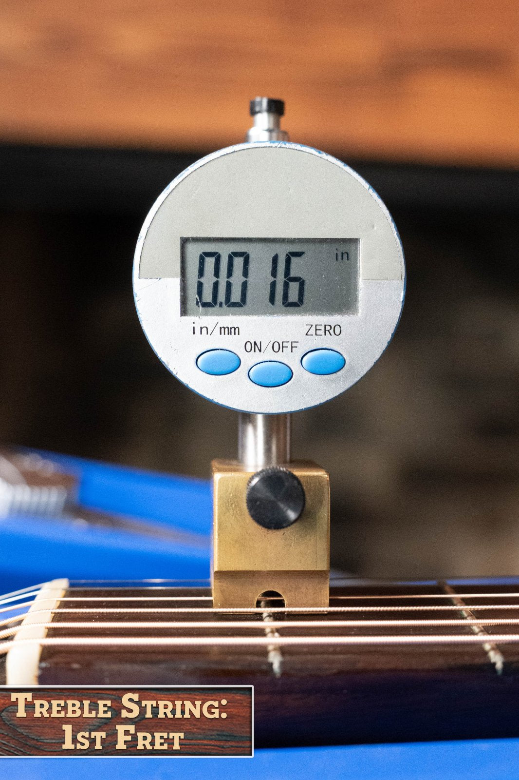 A digital gauge reads 0.016 inches when measuring the treble string height above the 1st fret of a (Used) 1958 Gibson LG-1 Spruce/Mahogany Acoustic Guitar #2758 by Gibson—ideal action for this vintage model.