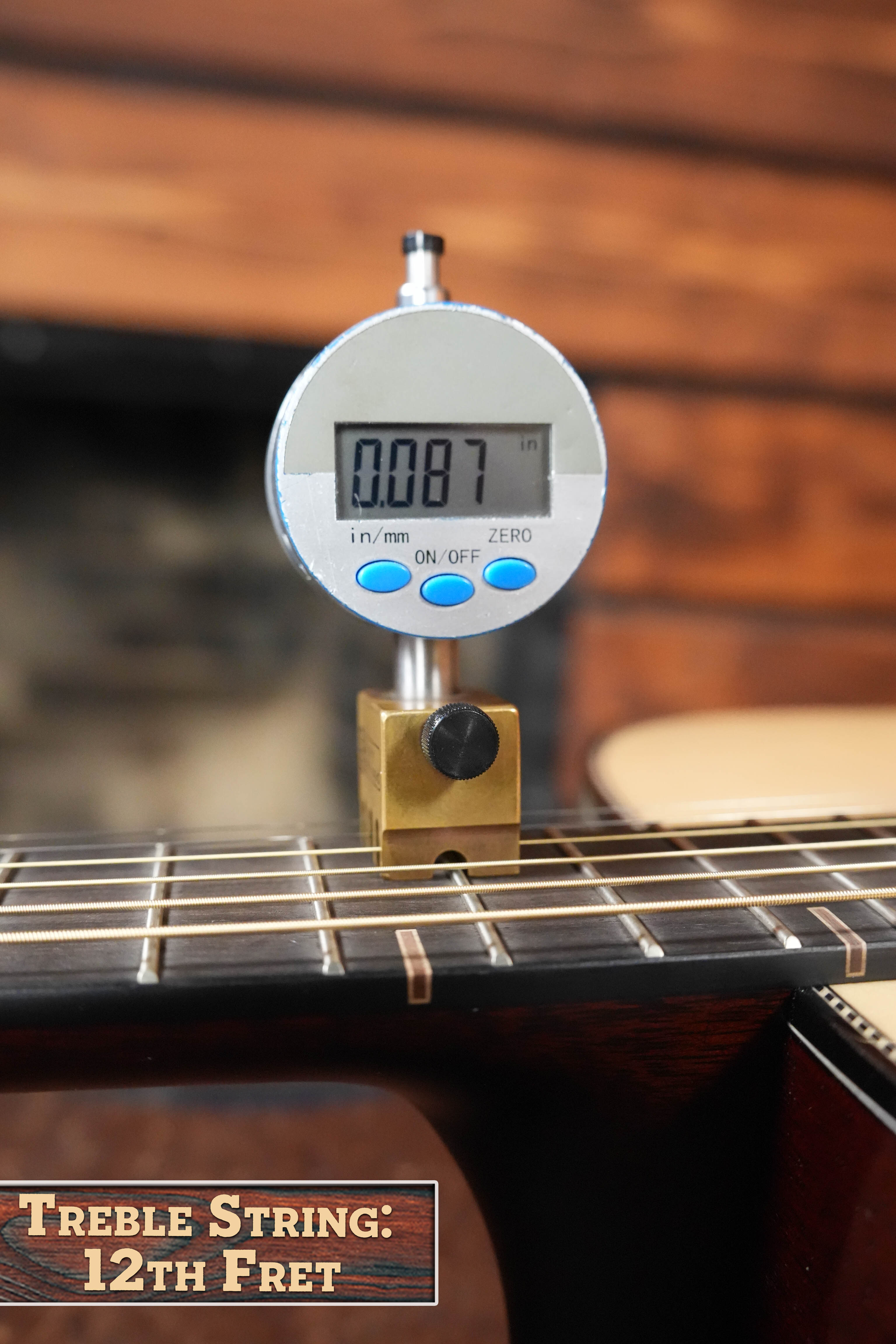 A digital gauge shows the treble string height above the 12th fret on a Yamaha FG9 M Adirondack/Mahogany Dreadnought Acoustic Guitar #112A as 0.087 inches, ensuring perfect setup for optimal Yamaha acoustic tone.
