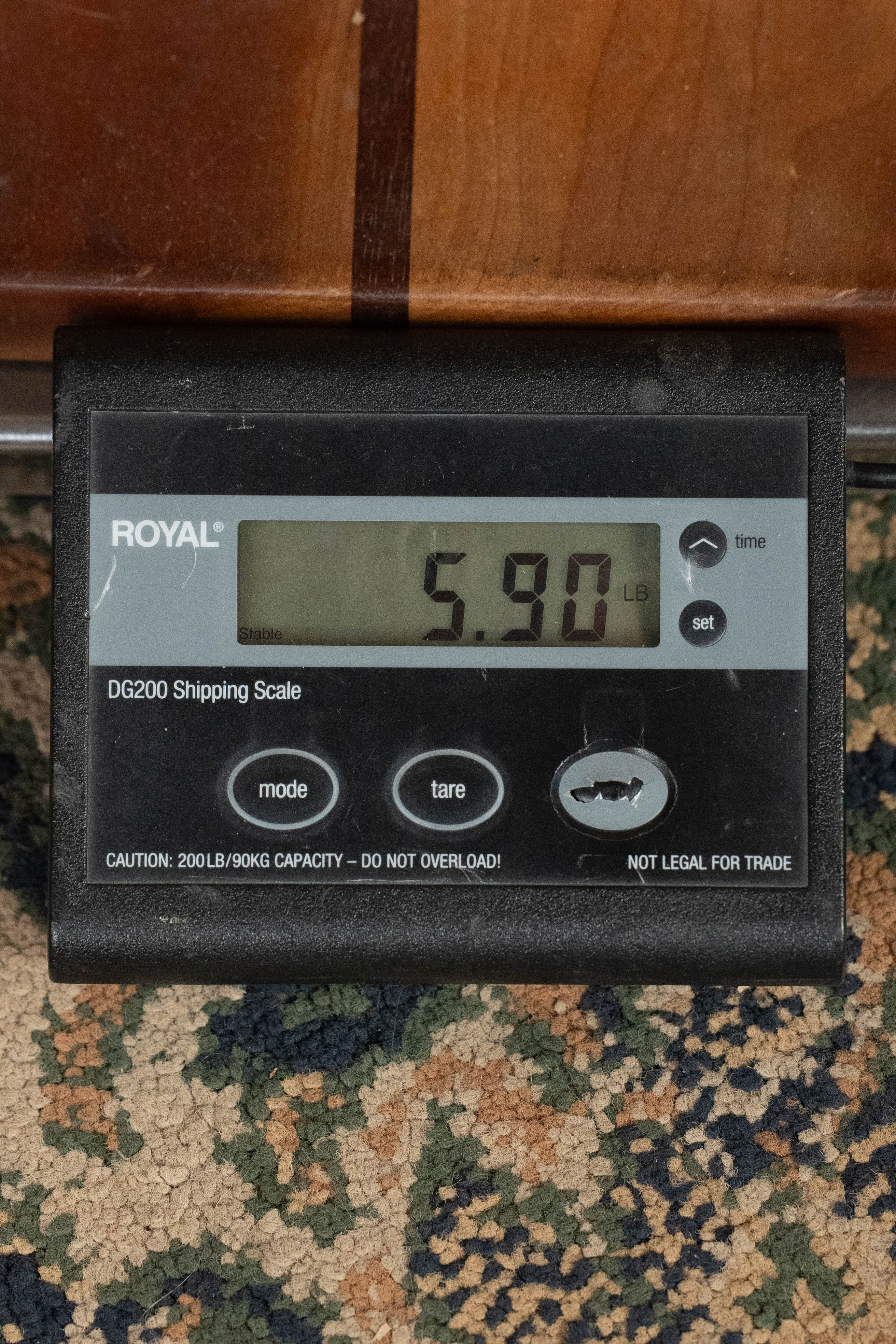 A digital shipping scale shows 5.90 lbs. The “ROYAL” DG200 scale sits on a patterned carpet next to a Yamaha TAG3C-NT Sitka/Mahogany Natural Dreadnought Guitar with the newest TransAcoustic System (#0558).