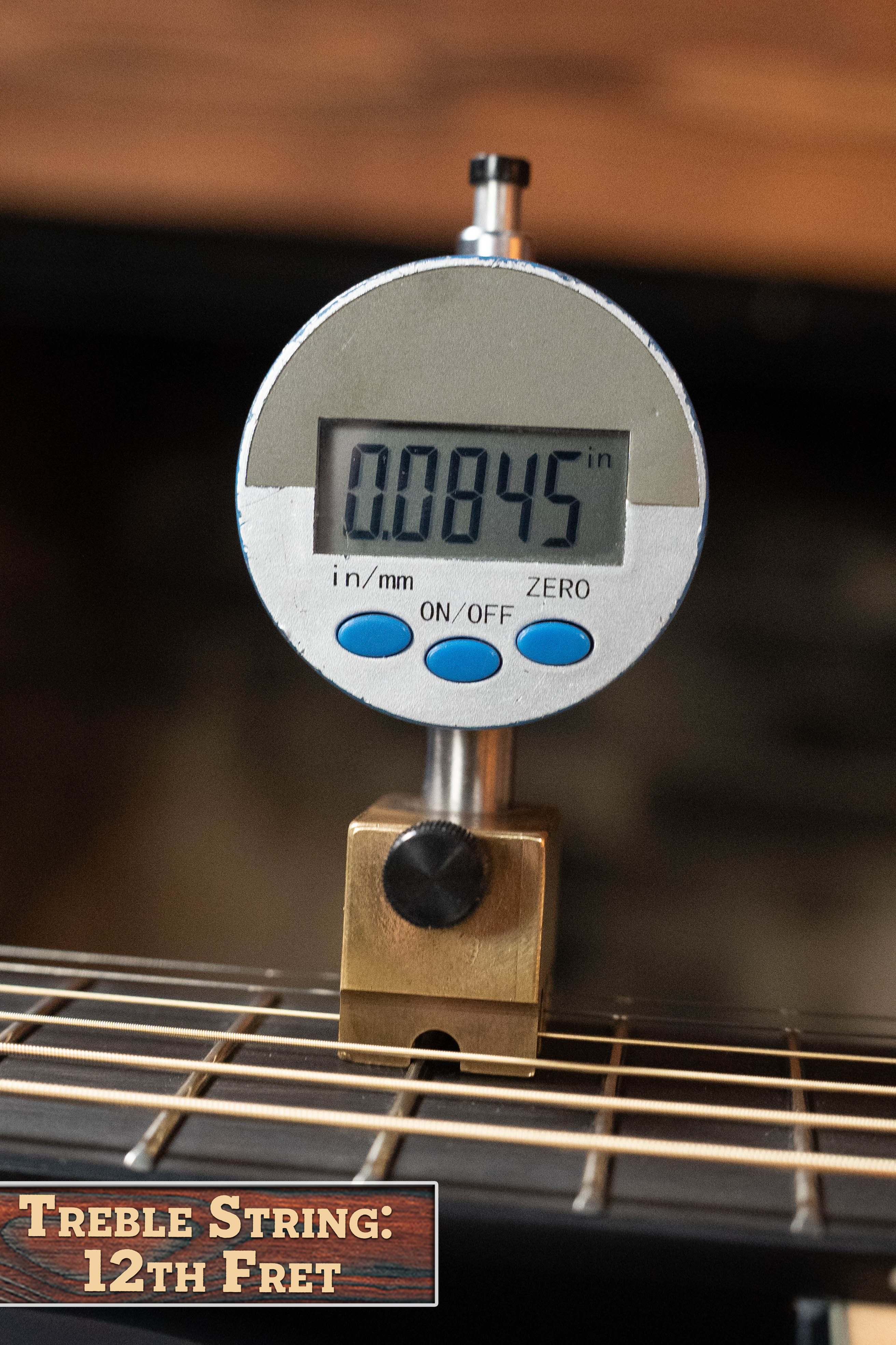 A digital gauge reads 0.0845 inches above the 12th fret of a Yamaha TAG3C-NT Sitka/Mahogany Natural Dreadnought Guitar w/NEWEST TransAcoustic System #0558. Label: Treble String: 12th Fret.