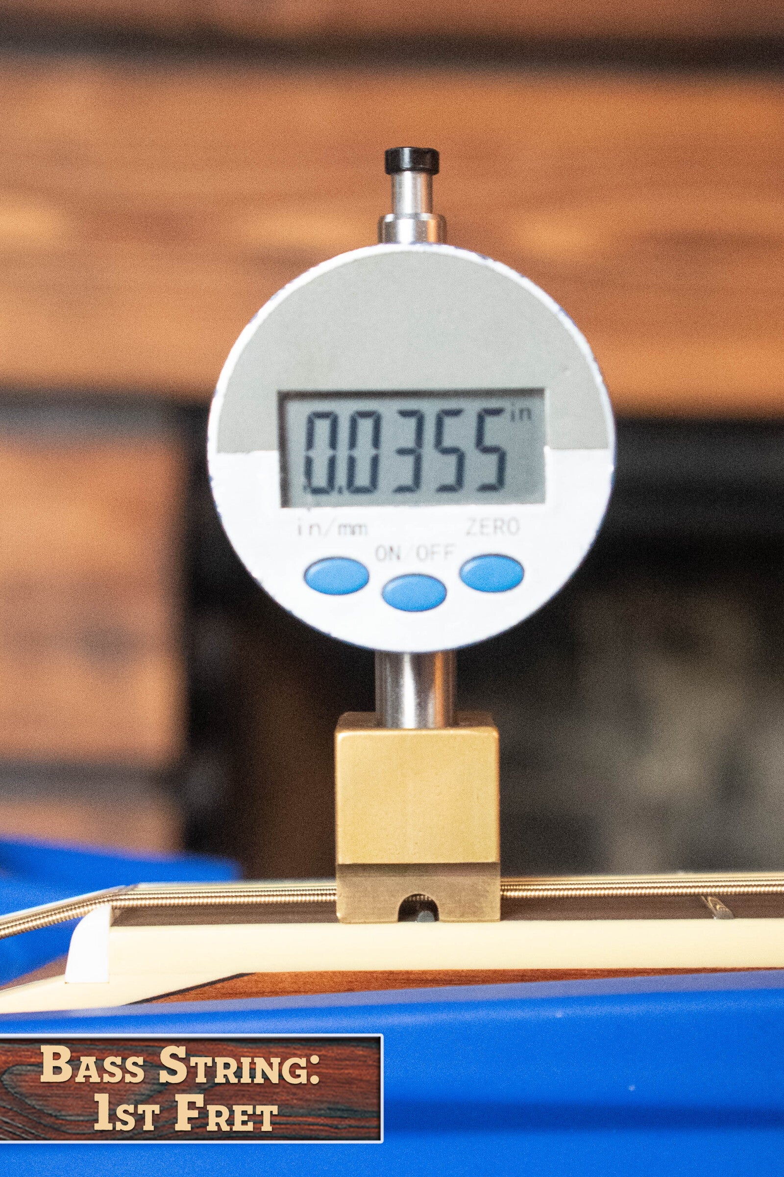 A digital caliper shows 0.0355 inches above the bass string at the 1st fret of a Yamaha FG830 Spruce/Laminate Rosewood Natural Dreadnought Acoustic Guitar (#0600). Label: BASS STRING: 1ST FRET.