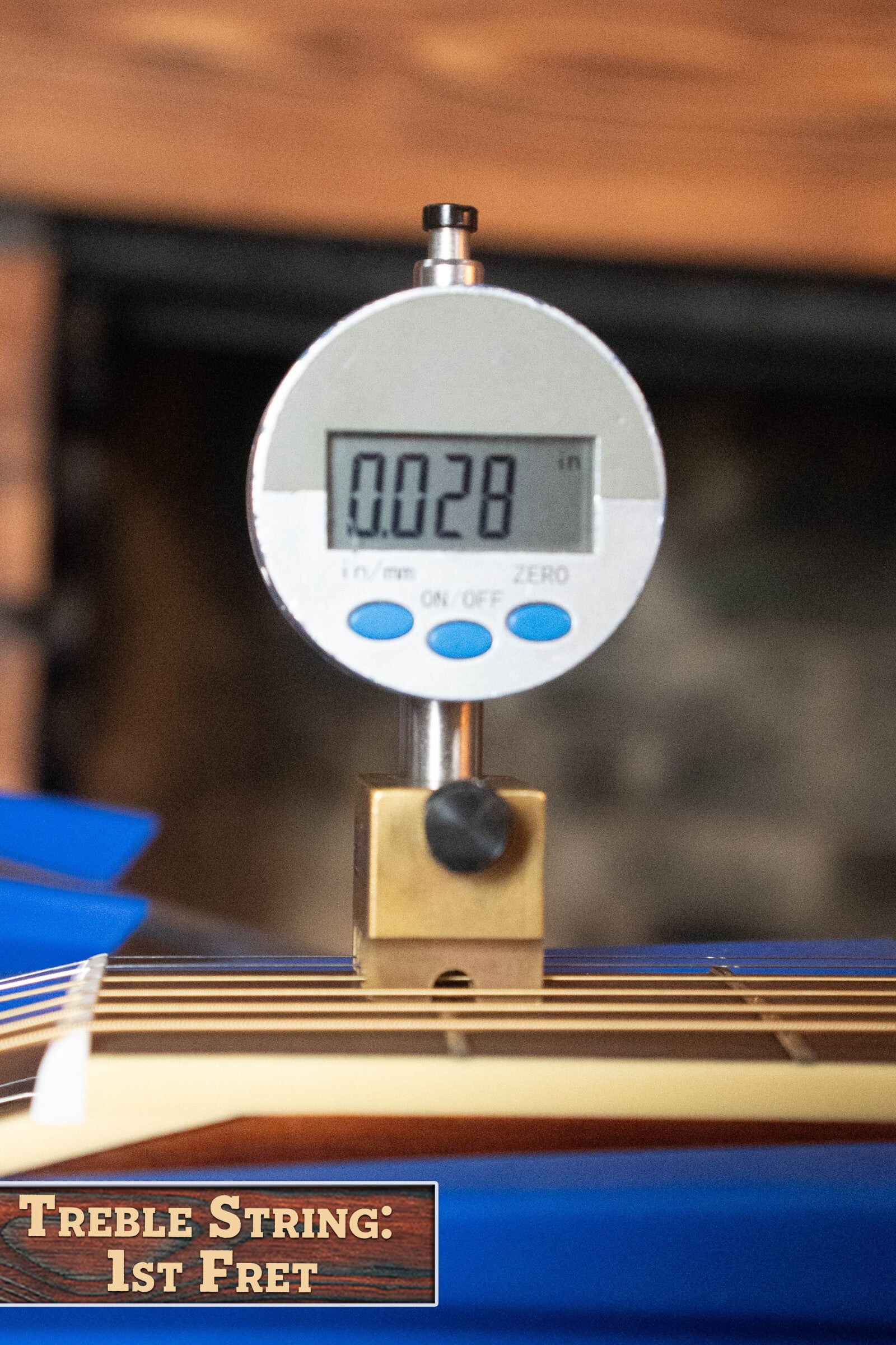 A digital gauge shows 0.028 inches string height above the 1st fret of a Yamaha FG830 Spruce/Laminate Rosewood Natural Dreadnought Acoustic Guitar #0600, with a label reading Treble String: 1st Fret and a blurred background.