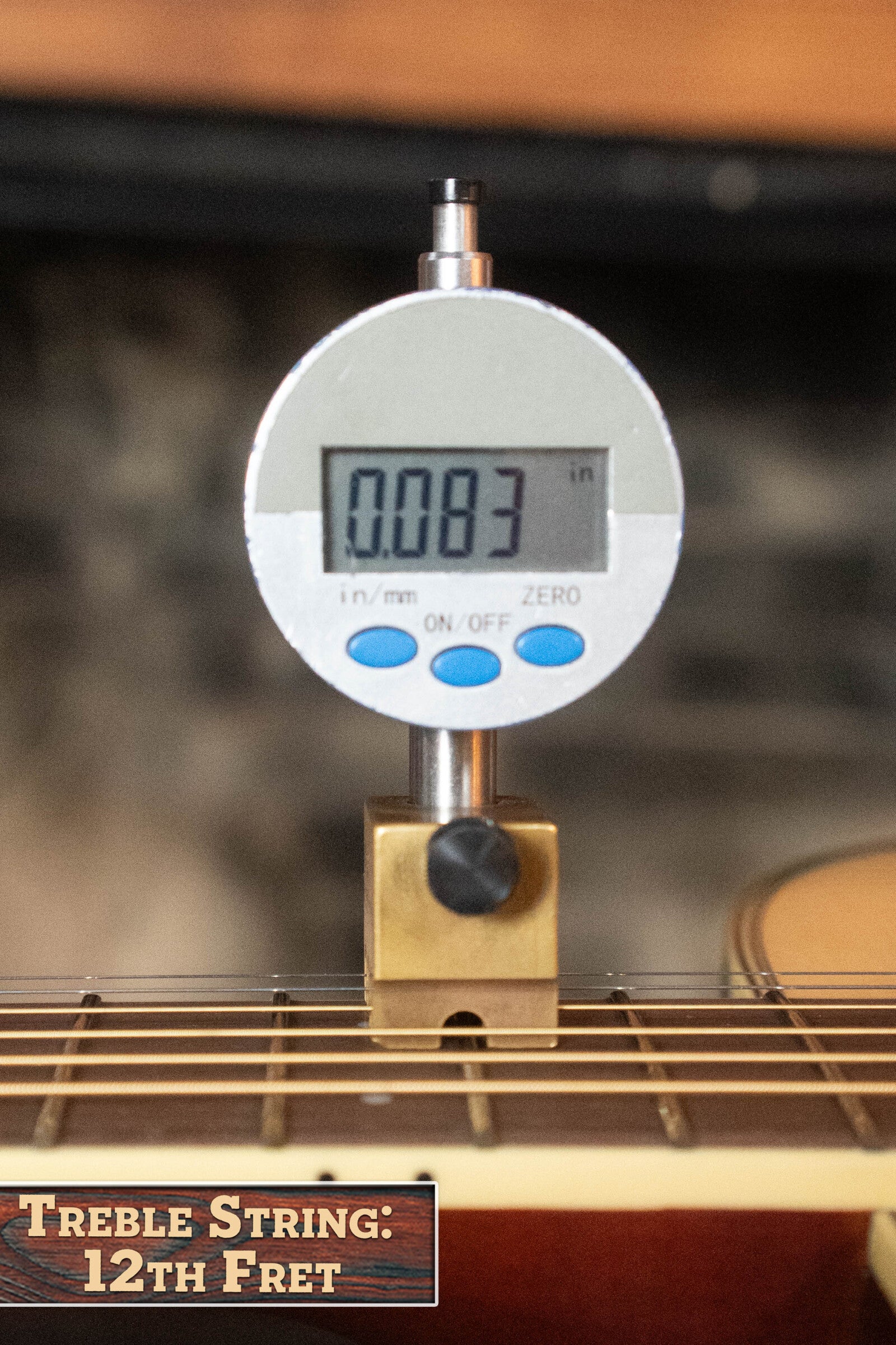 A digital gauge reads 0.083 inches on the 12th fret treble string of a Yamaha FG830 Spruce/Laminate Rosewood Natural Dreadnought Acoustic Guitar #0600. A label at the lower left states, “Treble String: 12th Fret.”.
