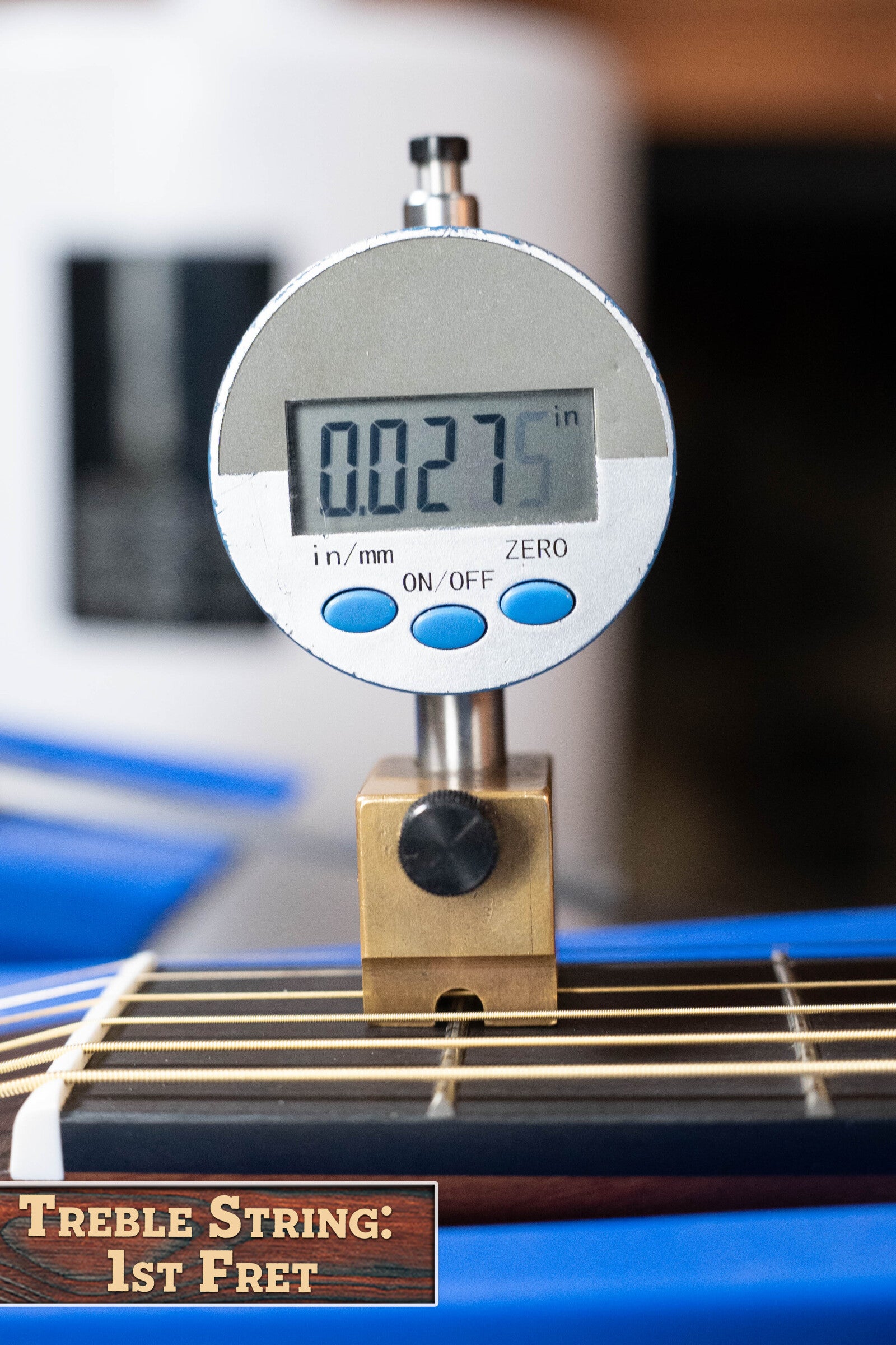 A digital gauge reads 0.0275 inches measuring the treble string height at the 1st fret of a Yamaha GigMaker Deluxe Acoustic Pack - Natural Finish #8229. A label at the lower left shows: Treble String: 1st Fret.