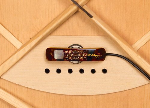 Close-up of an L.R. Baggs Lyric Acoustic Guitar Microphone with TRU•MIC technology installed near the soundhole, cable attached, and several small round sound holes below the pickup.