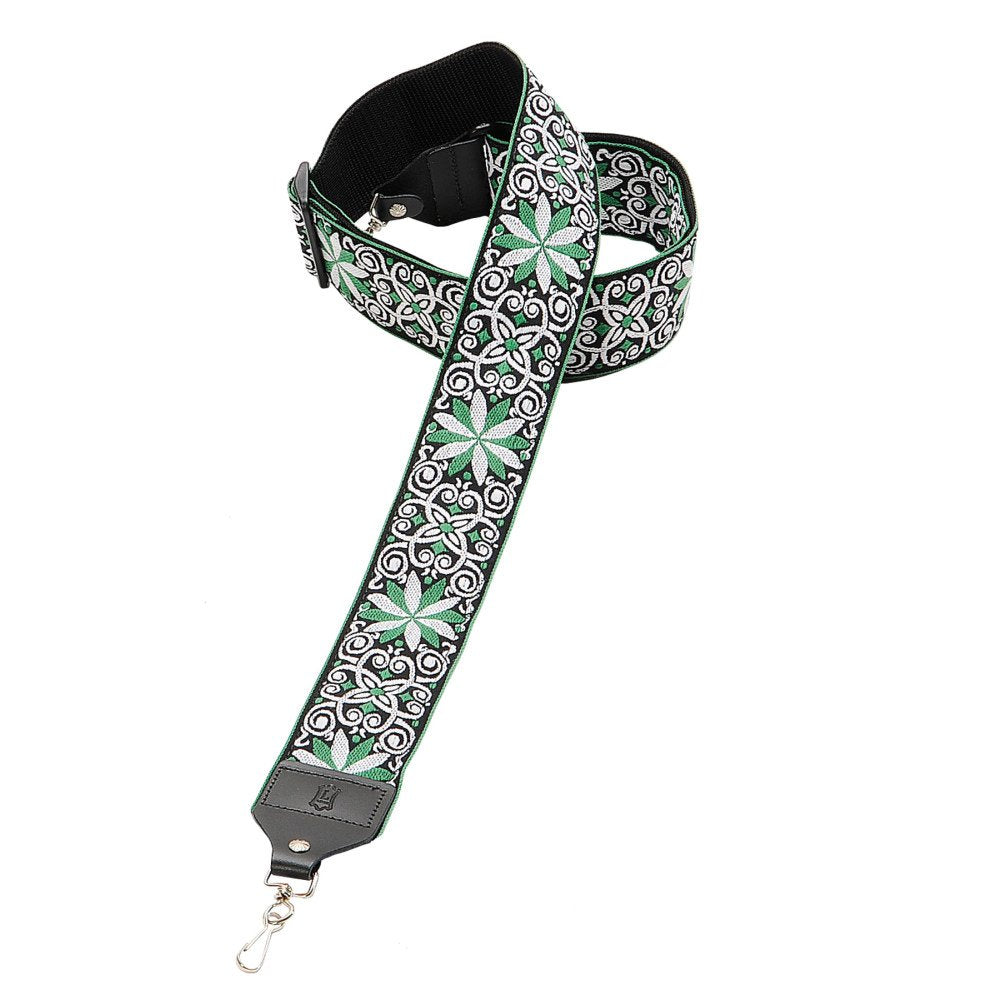The Levys Leather M10HT-11 Hootenanny Jacquard Banjo Strap features green, white, and black geometric and floral patterns, with leather ends and an adjustable black webbing.