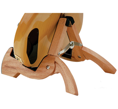 A close-up of the Cooperstand Pro-G Instrument Stand by Cooperstand, securely holding an acoustic guitar. Made from smooth African Sapele hardwood, it features curved polished legs and a metal hinge for stability.