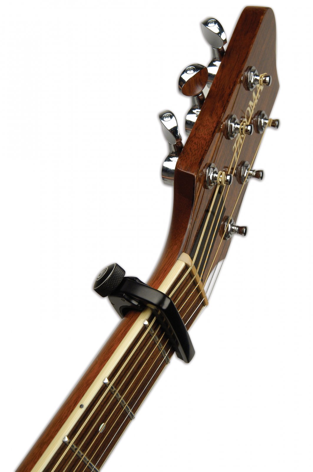 Close-up of an acoustic guitar headstock with six tuning pegs and a D'Addario NS Capo Lite PW-CP-07 clamped just below the nut, partially covering the strings.