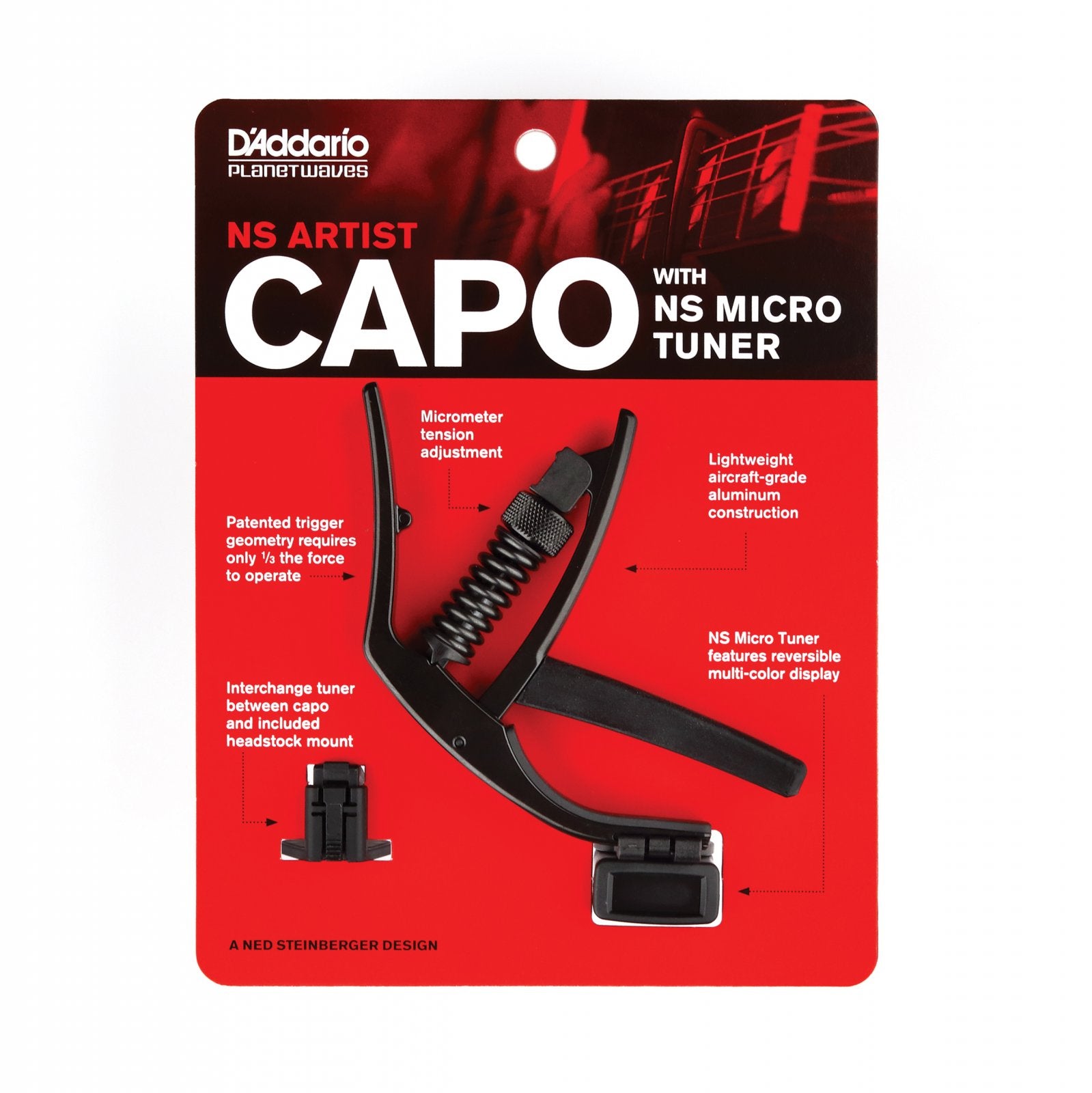 The D'Addario NS Artist Capo with NS Micro Headstock Tuner (PW-CP-10NSM) in black features micrometer tension adjustment and an interchangeable tuner mount, shown on red packaging.