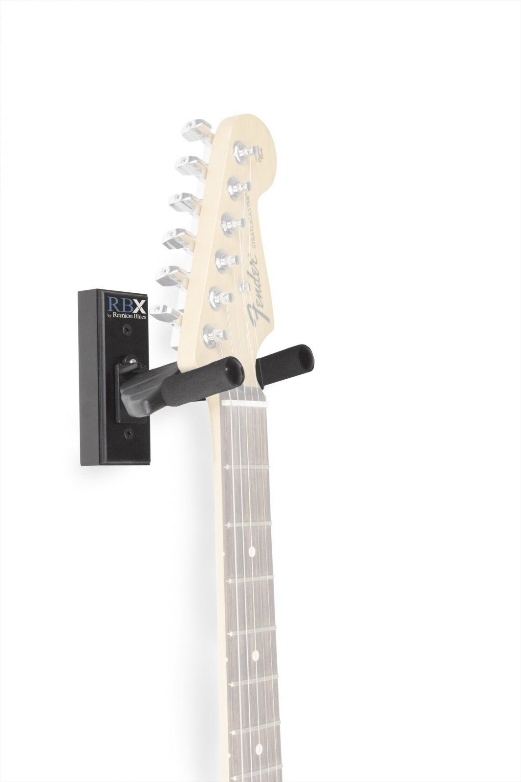 A light electric guitar hangs vertically from a Reunion Blues RBXS-WHBK Guitar Wall Hanger (Black) with a self-locking yoke, mounted on a white background. The Reunion Blues brand hanger supports the visible headstock and part of the neck.
