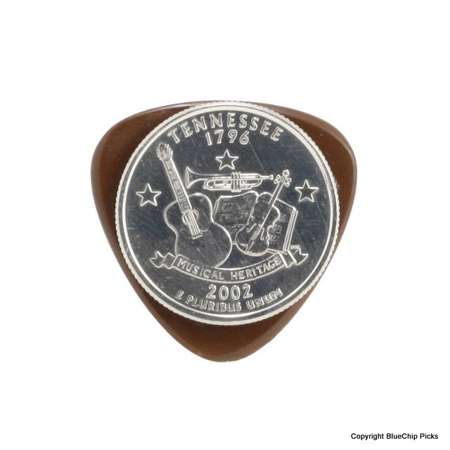A Tennessee state quarter with musical instruments and "Musical Heritage" rests atop a BlueChip Picks (TPR45) precision machined guitar pick by BlueChip.