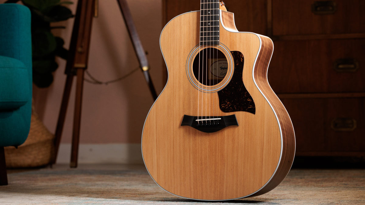 Taylor 200 Series lifestyle photo — guitar in a sunlit living room, The Acoustic Shoppe