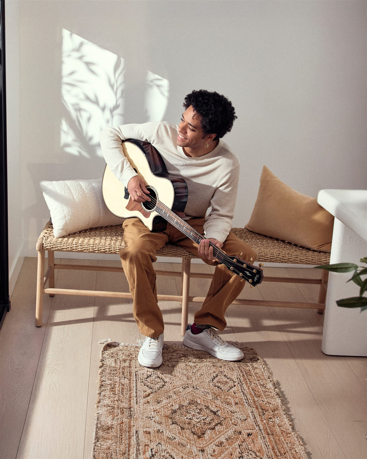 Taylor Builder's Edition lifestyle photo — musician playing a Builder's Edition 814ce at home, The Acoustic Shoppe