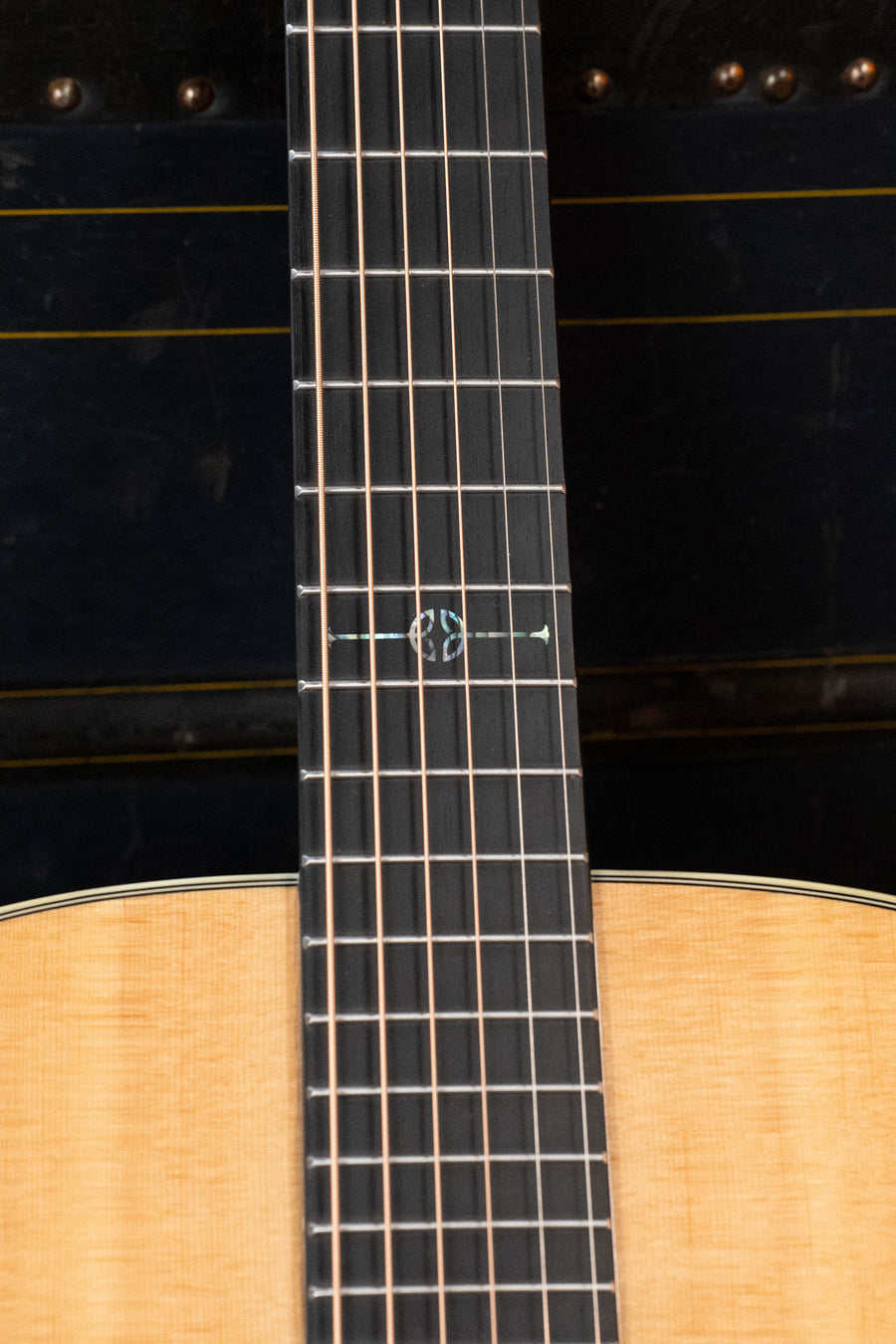 Close-up of the Alvarez Laureate Series LF70e Herringbone Sitka/Rosewood OM w/LR Baggs Hifi Pickup #3036’s neck and fretboard, featuring detailed twelfth-fret inlay above a solid Sitka spruce body, set against a dark background.