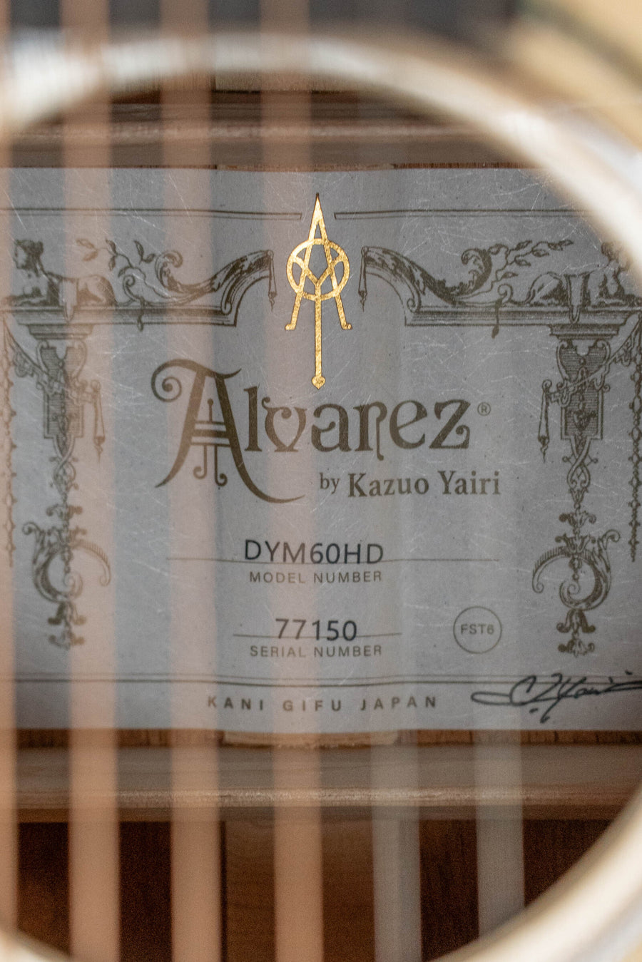Alvarez Yairi Honduran mahogany dreadnought acoustic guitar label with ornate vintage design visible through soundhole. - Alvarez Yairi Honduran Series DYM60HD Adirondack/Vintage Honduran Mahogany Dreadnought Acoustic Guitar #7150 - Default Title