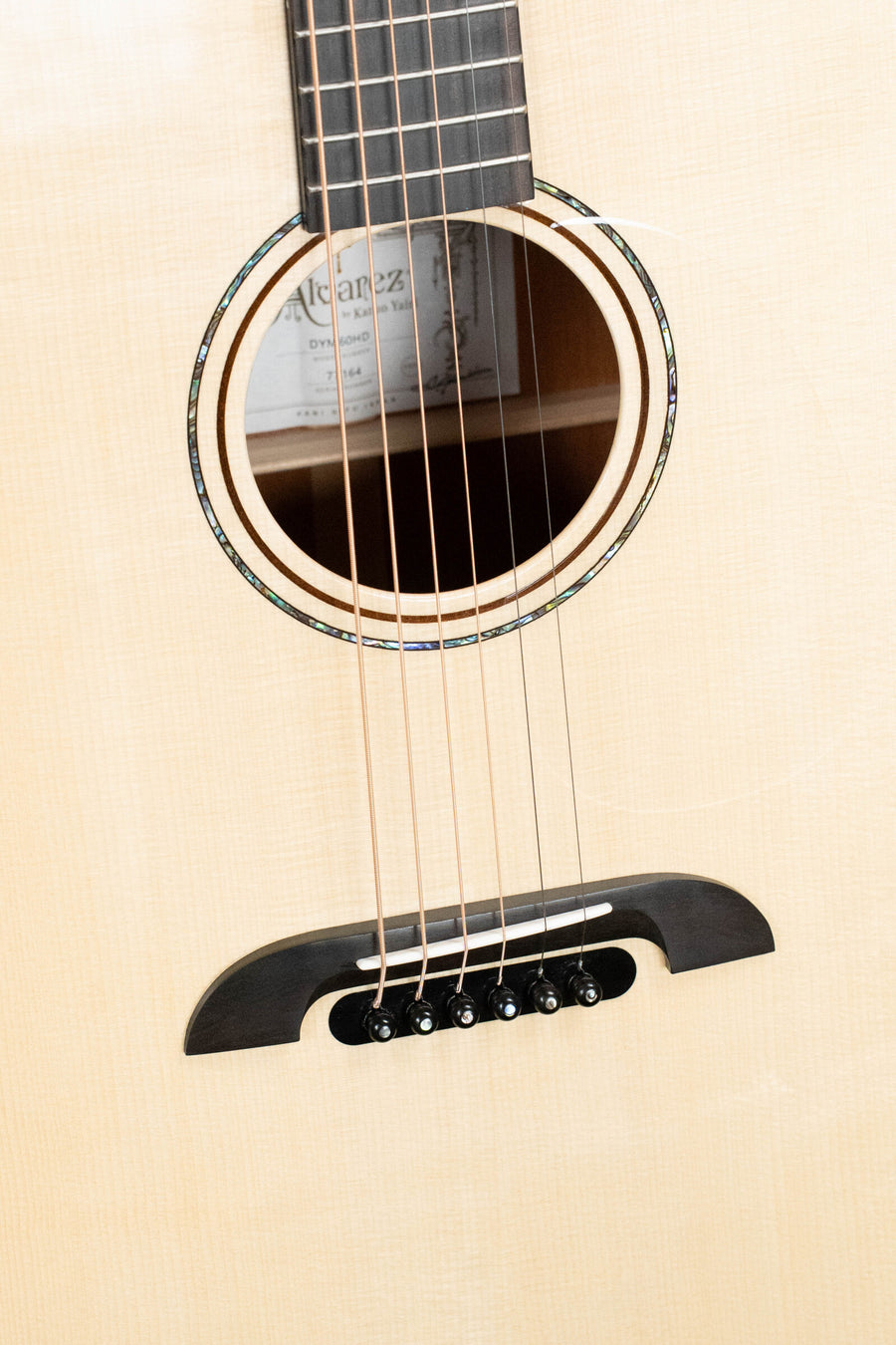 Close-up of natural Honduran mahogany dreadnought acoustic guitar body with black bridge and six steel strings. - Alvarez Yairi Honduran Series DYM60HD Adirondack/Vintage Honduran Mahogany Dreadnought Acoustic Guitar #7164 - Default Title