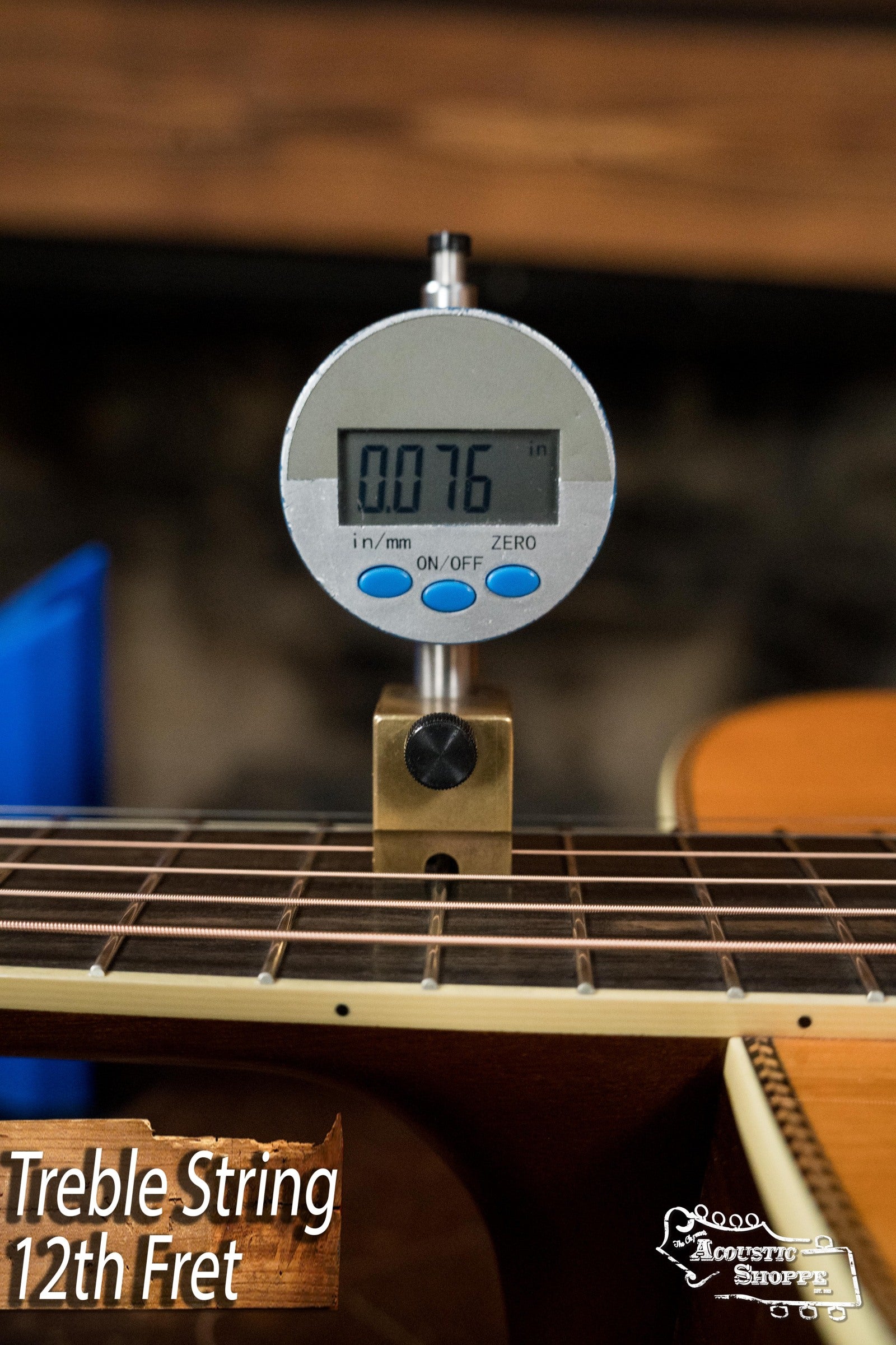 A digital gauge reads 0.076 inches for the treble string height at the 12th fret on an Atkin Guitars White Rice Baked Sitka/Rosewood Dreadnought Acoustic Guitar #3497. The image includes Treble String 12th Fret and Acoustic Shoppe text.