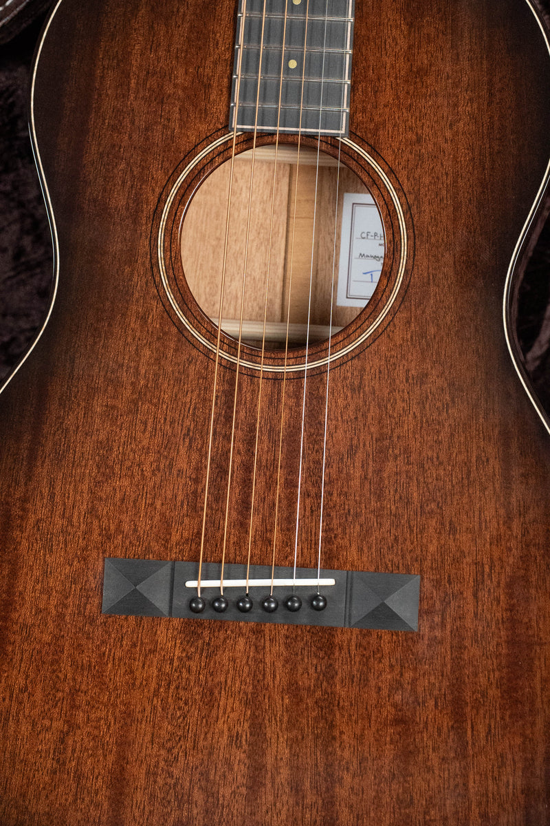 Bedell Classic Folk All Honduran Mahogany Parlor: front view, dark wood body, pyramid bridge, visible interior label.