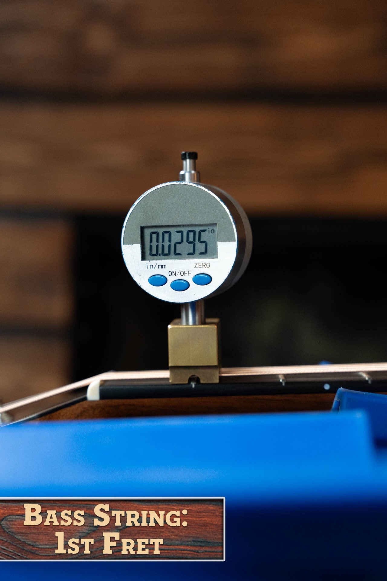 A digital gauge reads 0.0295 inches while measuring a string at the 1st fret, illustrating the precision needed for setup on a Boucher BG-42T-G Bluegrass Goose Series Dreadnought by Boucher Guitars. A label reads “Bass String: 1st Fret.”.