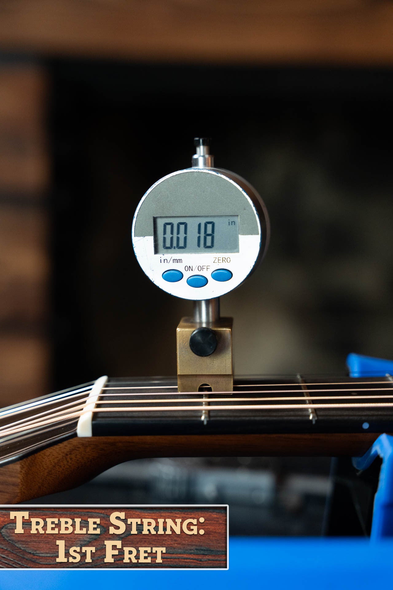A digital gauge shows a 0.018-inch string height at the first fret of a Boucher BG-42T-G Bluegrass Goose Series Dreadnought guitar, with “Treble String: 1st Fret” displayed in the lower left corner.