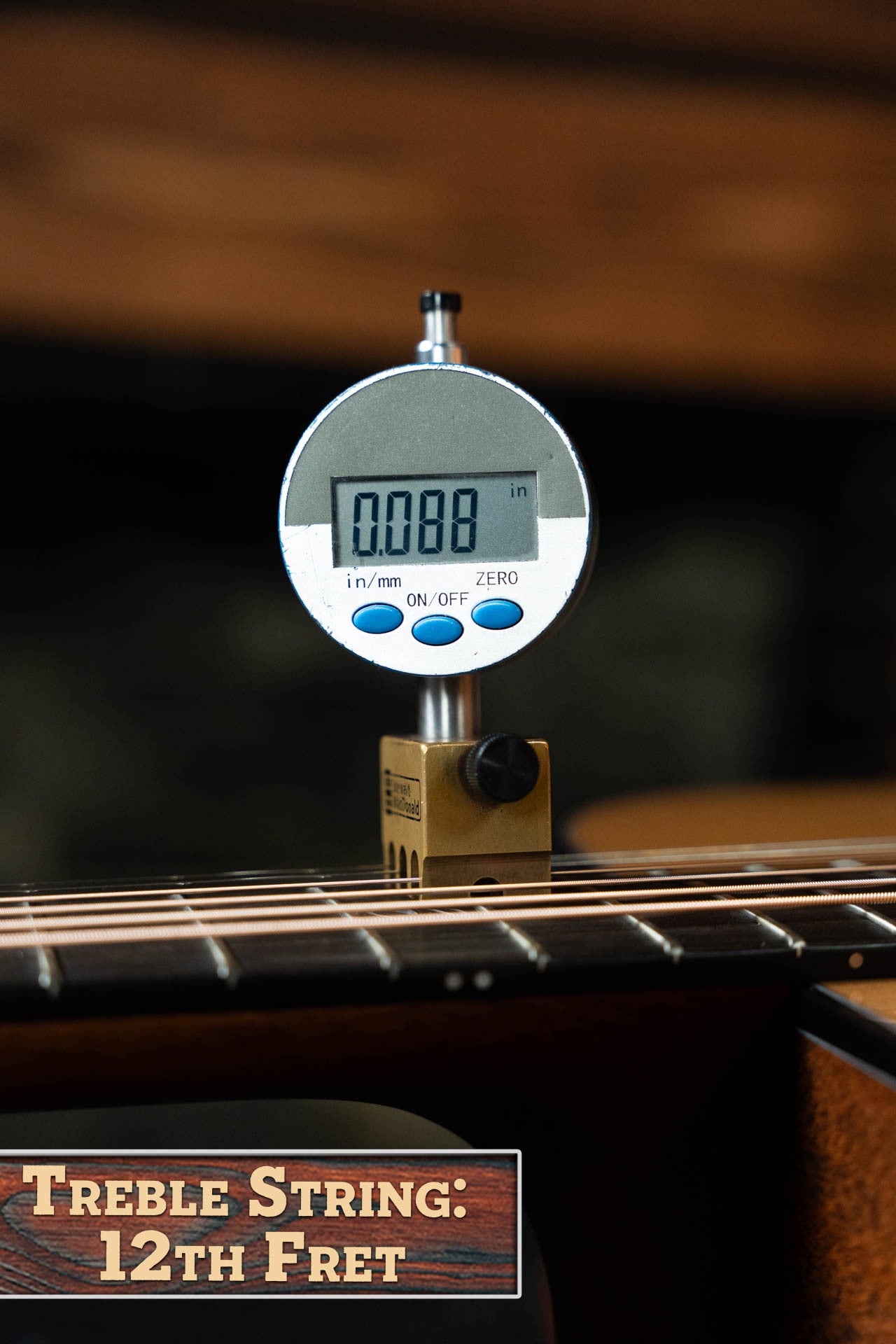 A digital gauge shows a 0.088-inch treble string height at the 12th fret on a Boucher BG-42T-G Bluegrass Goose Series Torrefied Adirondack/Mahogany Dreadnought Gold Pack Guitar by Boucher Guitars.