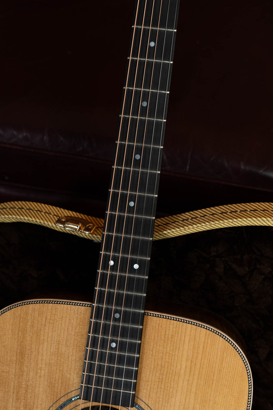 Close-up of the Boucher GR-SG-162T Grande Reserve Dreadnought Acoustic Guitar #1037 by Boucher Guitars, showcasing its light wood, decorative trim, and plush-lined case.