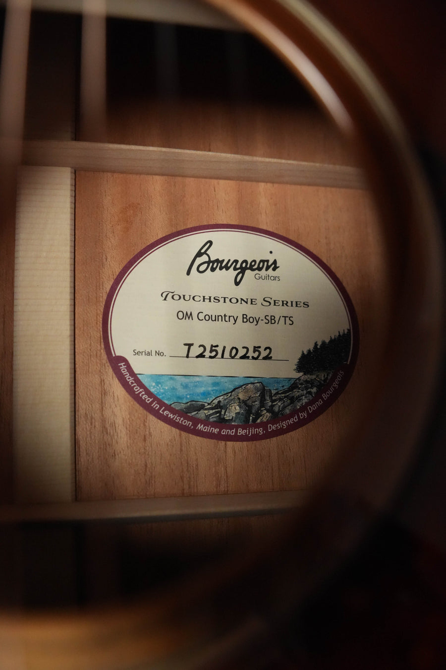 Close-up of the Bourgeois Country Boy Touchstone Series Sitka/Mahogany Sunburst Orchestra Model Acoustic Guitar #0252 label, visible through the guitar’s sound hole.